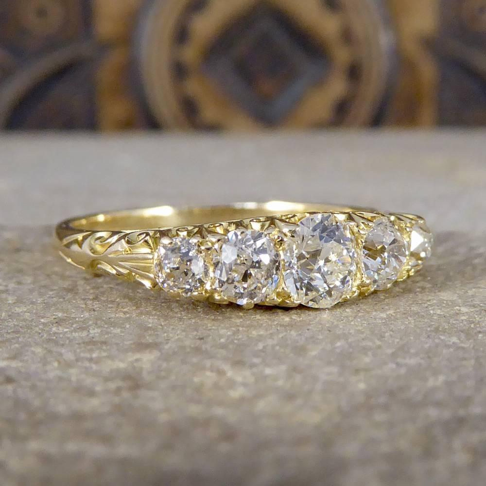 This beautiful antique ring has been crafted in the Late Victorian era. Set with five equally matched Old Cut Diamonds, with the centre stone being the largest and symmetrically graduating down in size to the outers. It has been hand crafted from