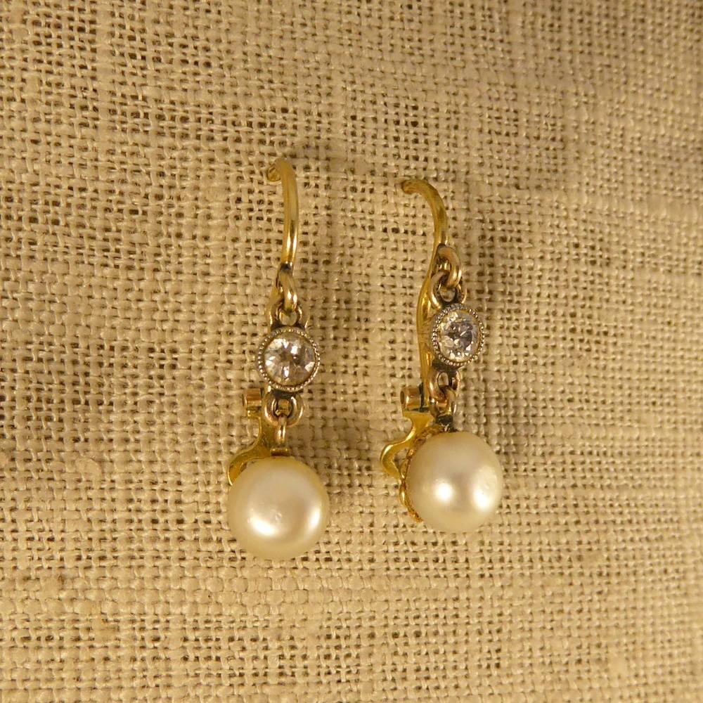 These antique earrings have been crafted in the Late Victorian period. They each feature a classic old cut diamond and a natural pearl with lovely lustre.

All set in 15ct yellow gold, they look delicate and divine when worn!

Condition: Very Good,