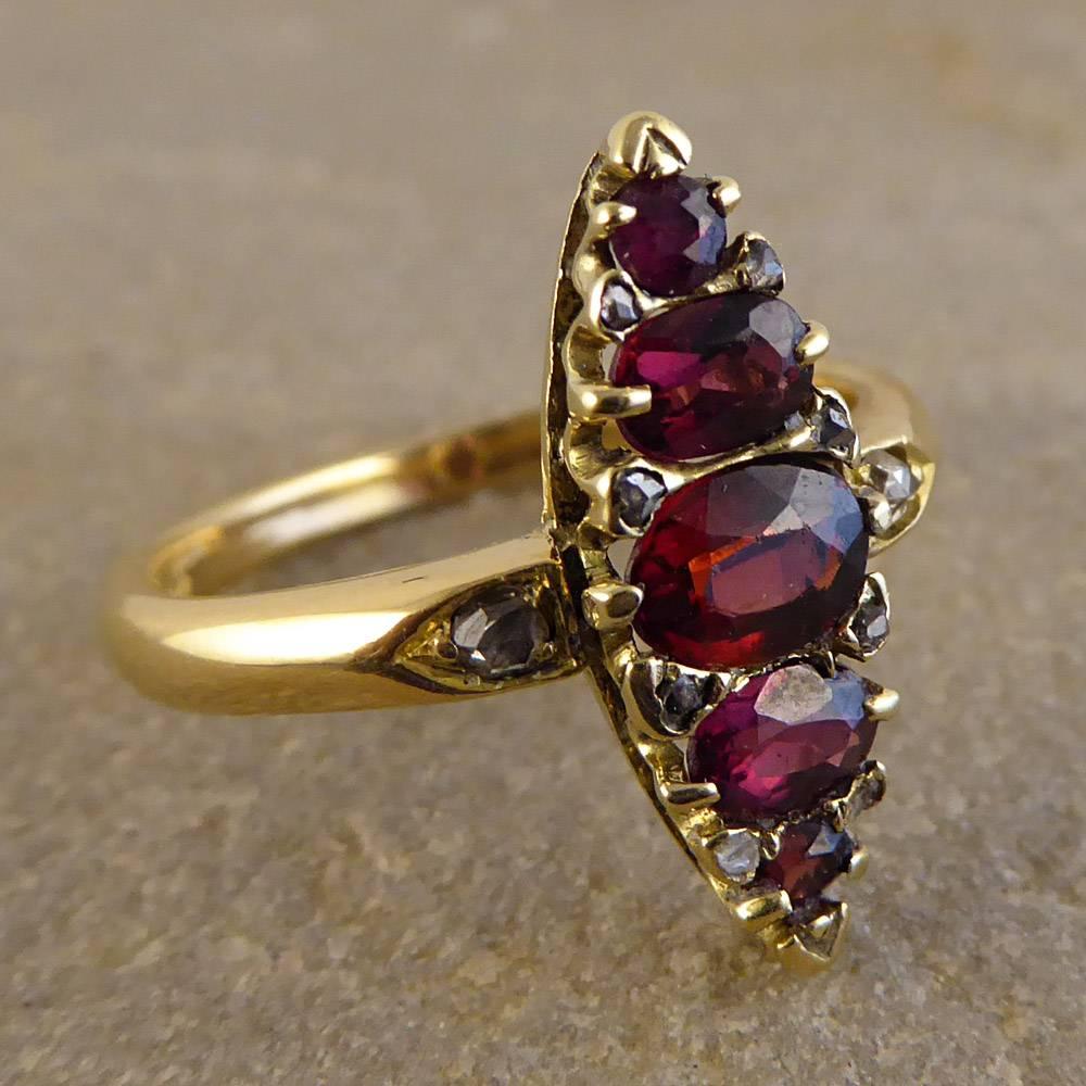 This Stunning Vintage Marquise Ring is set with five lustrous Garnet stones surrounded by old cut Diamonds. It has been crafted in 18ct Yellow Gold and looks divine on the finger! 

Ring Size: UK O 1/2 or US 7.25 

Condition: Very Good, slightest