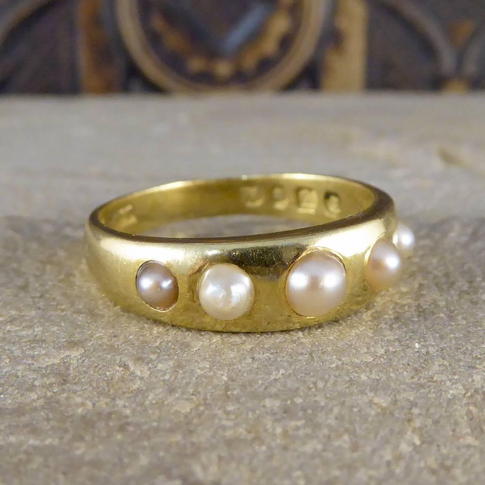 This classic antique ring sits wonderfully on the hand. Featuring five pearls sat in an 18ct yellow gold band it will add a gorgeous glow to any outfit!

Crafted in 1876 in the Late Victorian era, it is a truly charming piece.

Ring Size: UK R or US