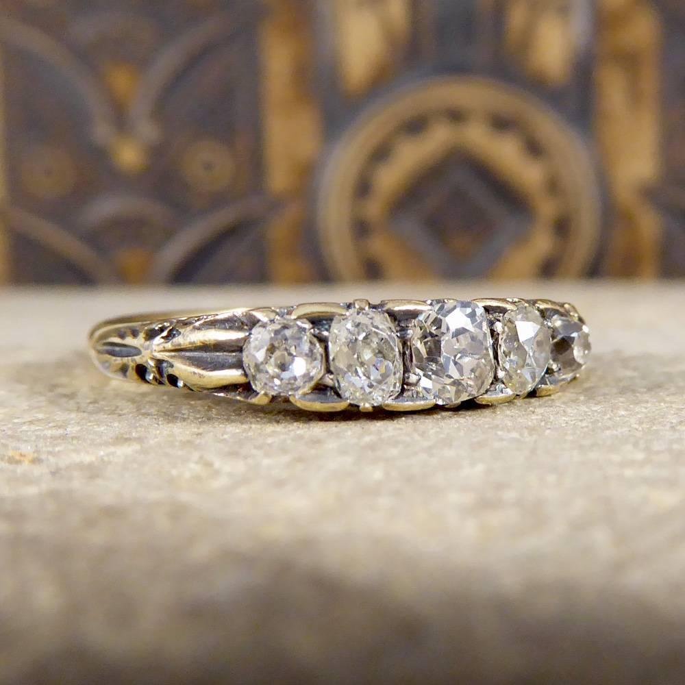 This original Late Victorian Ring has been crafted in 18ct Yellow Gold detailed with an intricate pierced openwork gallery profile, a very popular style during this era due to a limited supple of this precious metal. Set with Five Old-Cut Diamonds