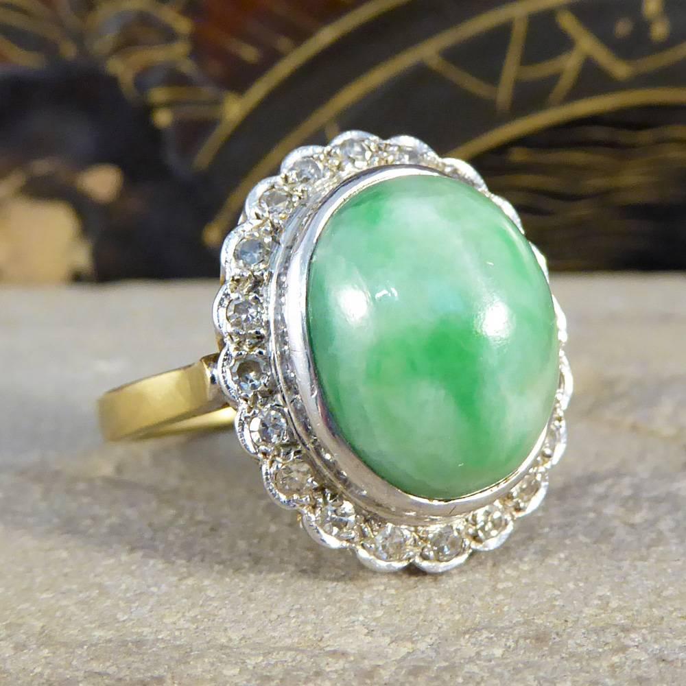 This bold 1970's cluster ring features a single jade stone surrounded by diamonds. The head is on an elevated gallery set in an 18ct yellow gold band. 

Large and lustrous, this piece screams opulence!

Ring Size: UK N or US 6.75

Condition: Very