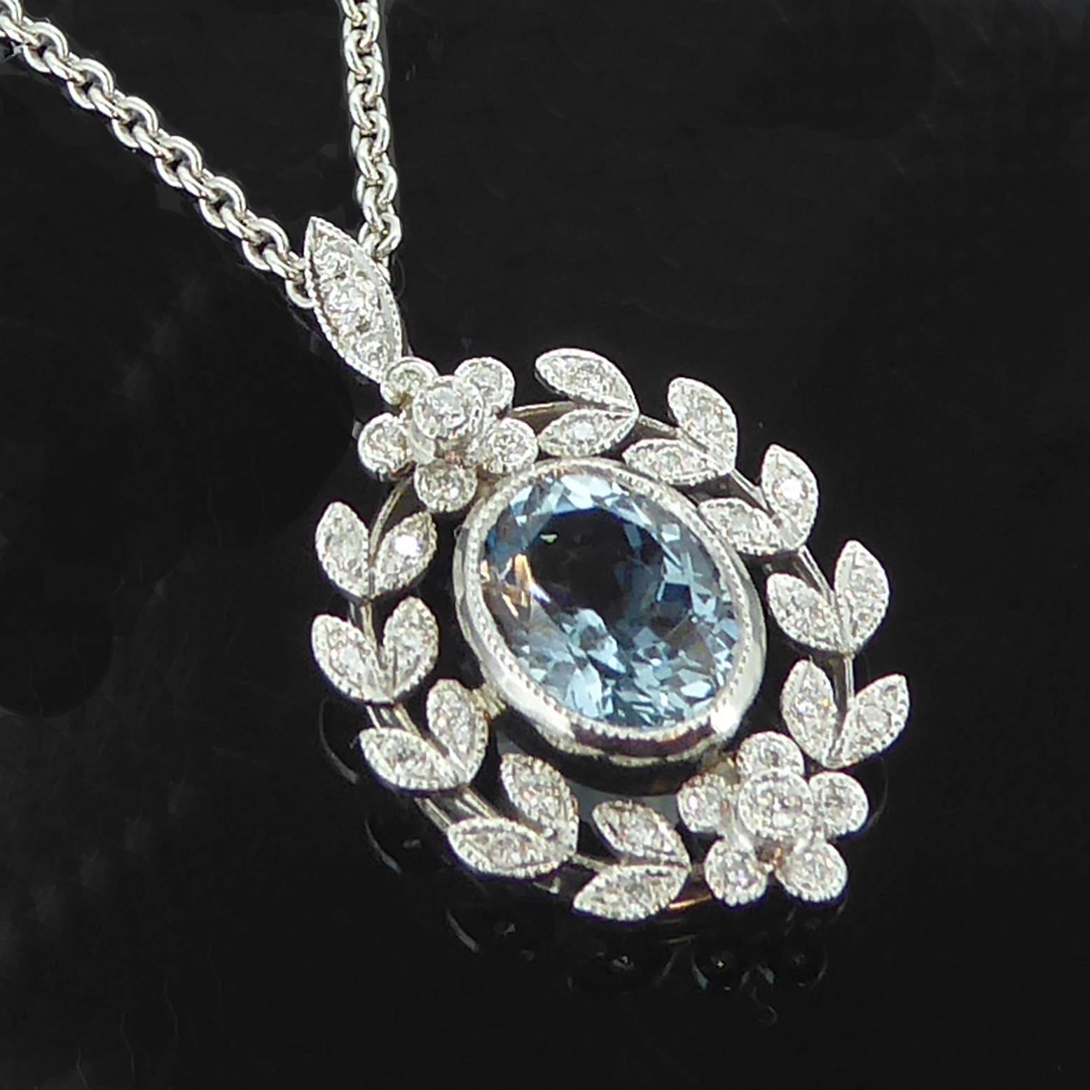 A refined an elegant antique style pendant created in the Belle Epoque style which lasted from the 1870s through to the outbreak of the 1st World War.  Set to the centre with an oval, mixed cut aquamarine of rich hue in a complimentary white metal