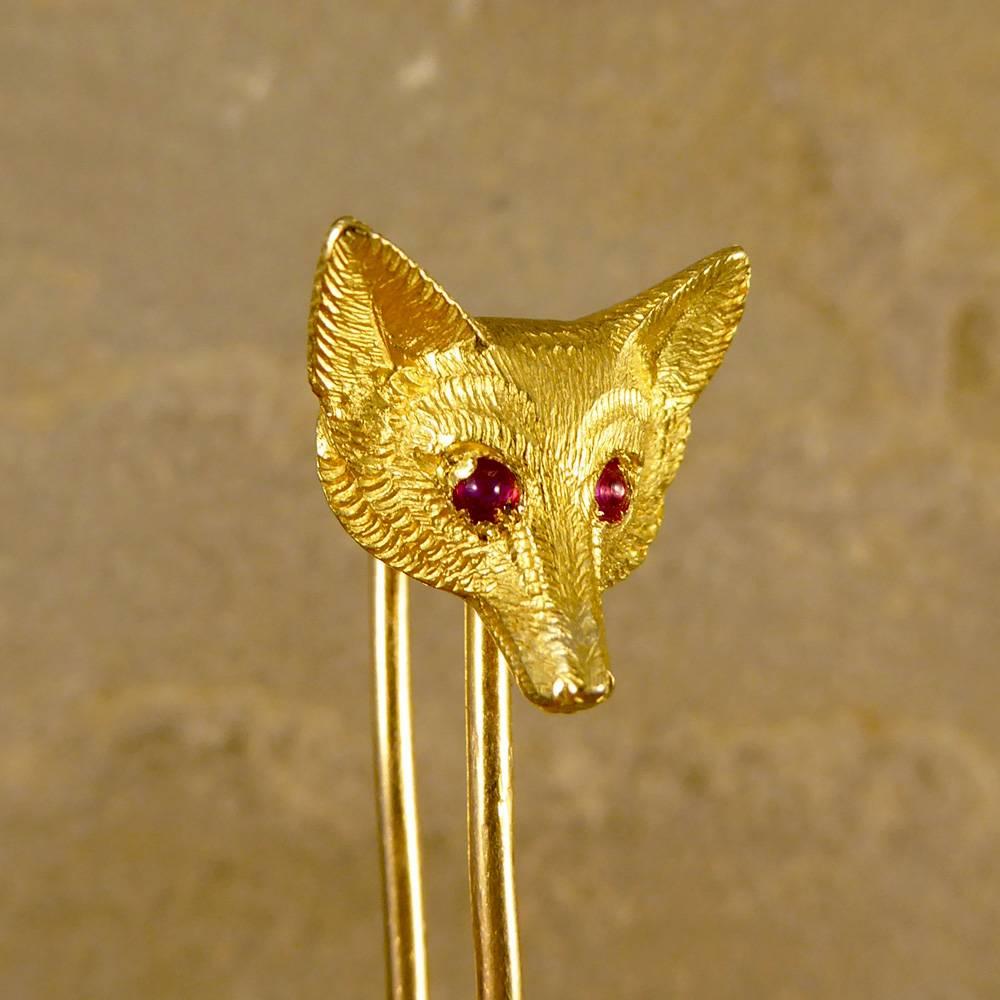 Typically used in the Edwardian era as a pin or brooch whilst hunting, this Fox Head brooch has been hand crafted in 15ct Yellow Gold, with Cabochon Ruby set eyes. This brooch has matching Cufflinks for someone who wants the whole set, product code