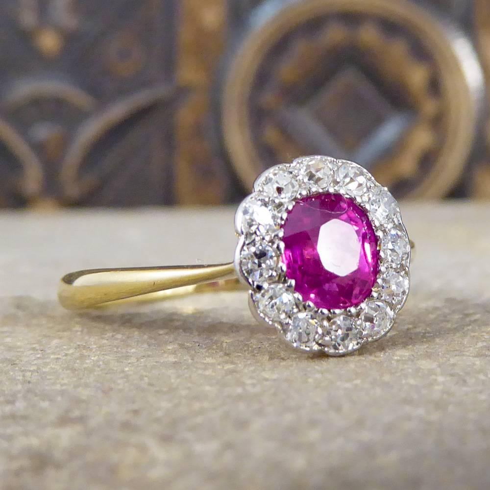 This stunning antique Ruby and Diamond Cluster Ring has been crafted in the Edwardian era. The 0.80ct Ruby is a lovely pink and is bead set framed by 12 chunky eight cut diamonds encircling the Ruby making it pop on the finger. The gemstones are set