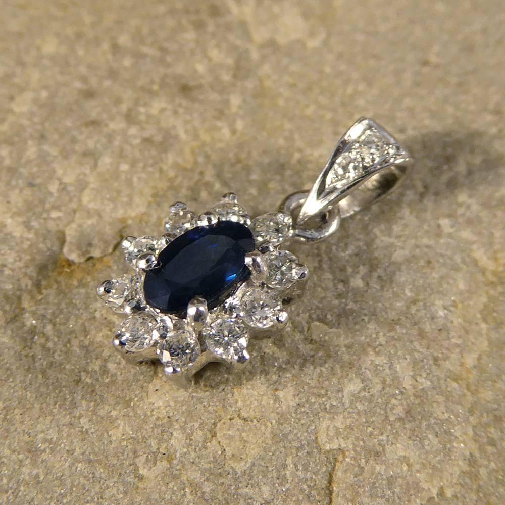 This stunning contemporary pendant has been modeled in 18ct white gold with a diamond accented bail. 
Featuring a single 0.20ct sapphire stone accented by surrounding diamonds, it will sit divinely on the neckline!

Condition: Very Good, slightest