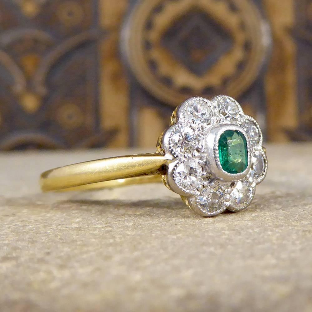 This beautiful 1930's ring features a 0.15ct Emerald in the centre and is surrounded by Diamonds weighing a total of 0.35ct. The head of the ring has been hand crafted from Platinum with a millegrain edge, leading down onto an 18ct Yellow Gold shank