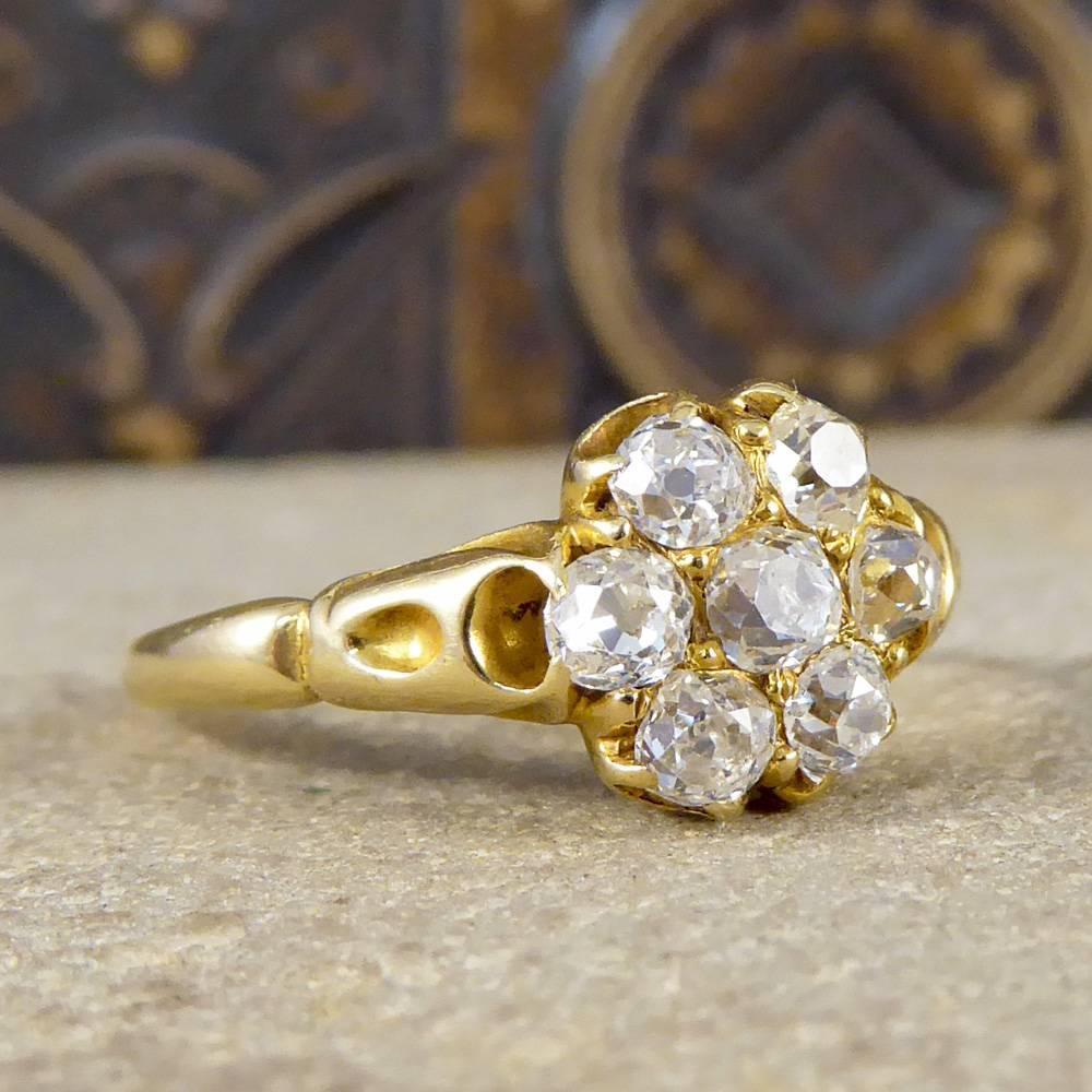 A traditional Victorian Diamond cluster ring from the late 18th century. Hand crafted from 18ct Yellow Gold, the ring features a 7 stone cluster of old cut Diamonds. Each Diamond is completely unique due to having been individually hand cut. The