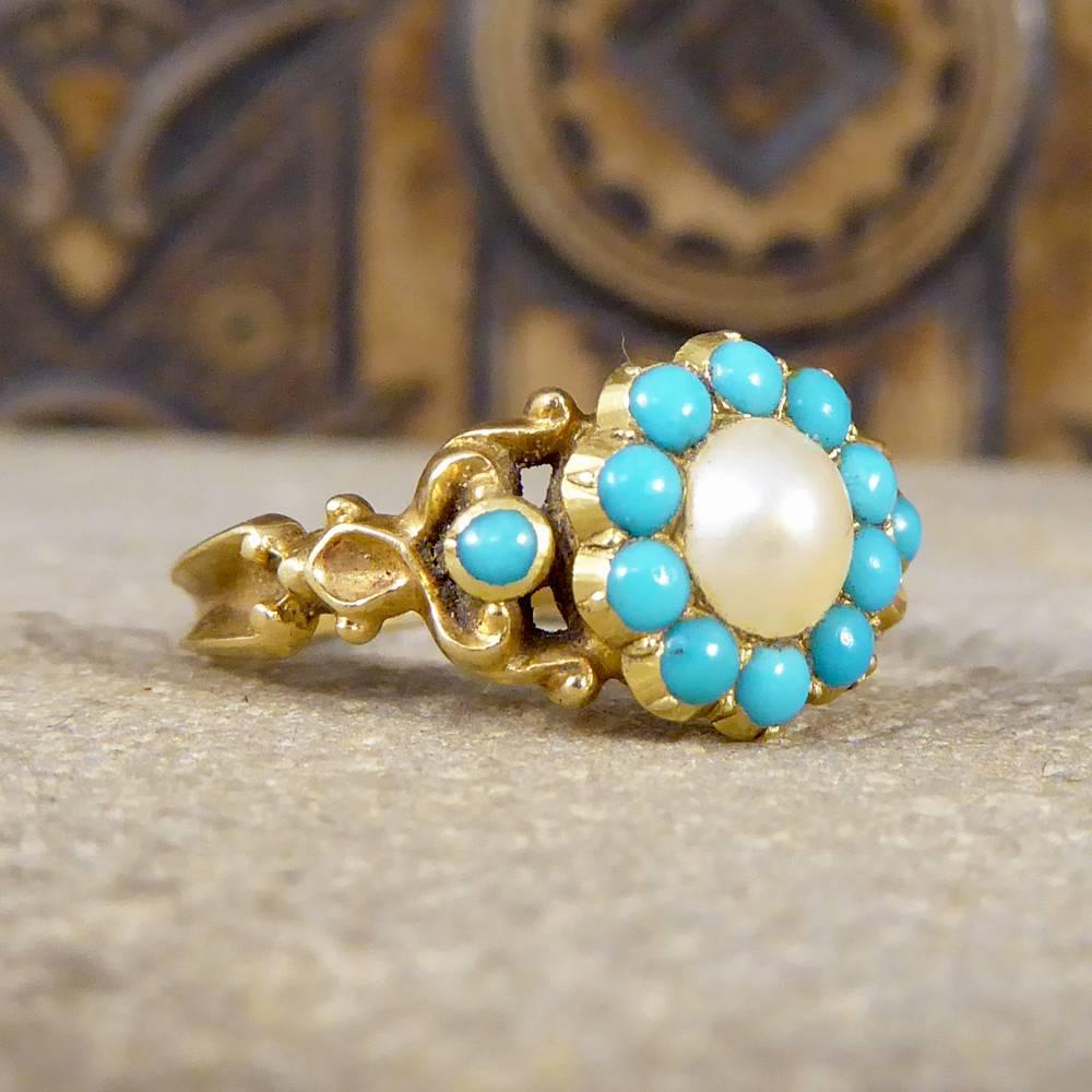The Pearls and Turquoise used in this ring have been arranged to resemble a floral shape, with beautifully detailed shoulders set with Turquoise. This Early Victorian ring has been crafted in unmarked yellow Gold and has an enclosed locate in the