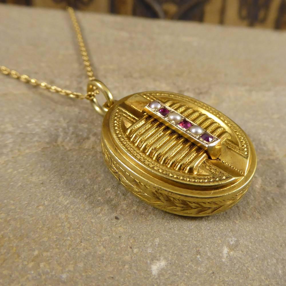 This lovely 15ct Yellow Gold locket was hand crafted in the Late Victorian Era showing exquisite detailing on the front, back and side. It is set with three Garnets and three Pearls down the centre. It has one compartment on the inside for