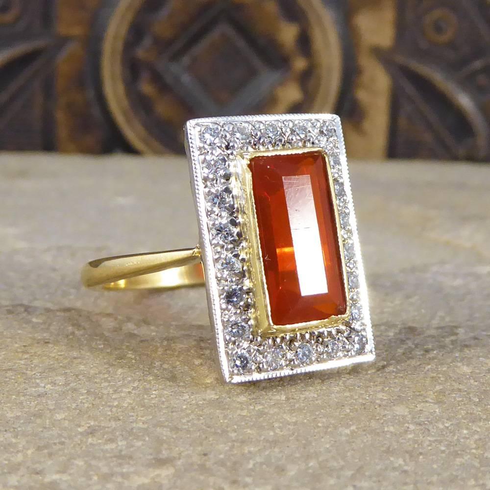 This absolutely stunning vintage ring has been crafted in the 1970's. Featuring an emerald cut Fire Opal centre stone of 1.86ct surrounded by diamonds, it looks exquisite on the hand!

Ring Size: UK M or US 6.25

Condition: Very Good, slightest