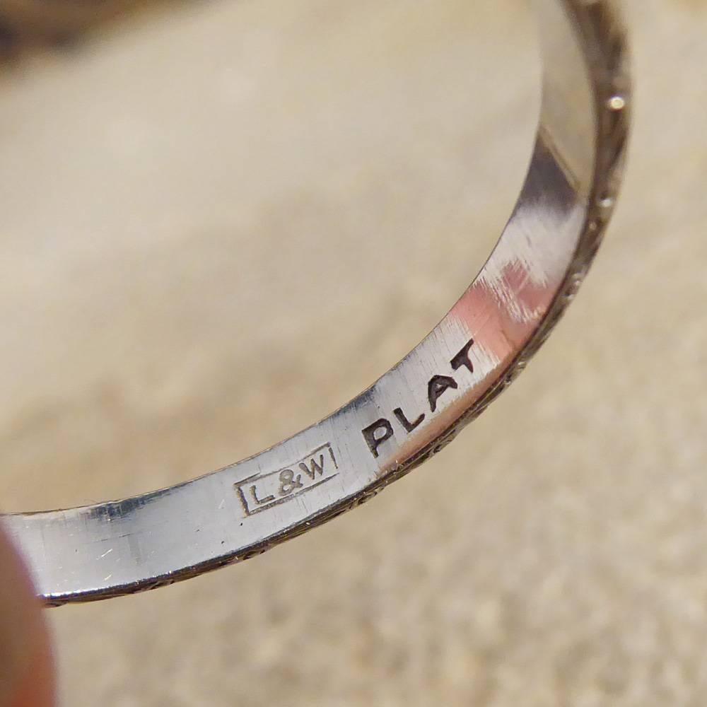 This simple Platinum band can be worn as a ring worn on any finger, or as a wedding band for both men and women. The decretive edge adds that extra special detailing for that extra special ring.

Ring Size: UK P or US 7.75 

Condition: Very Good,