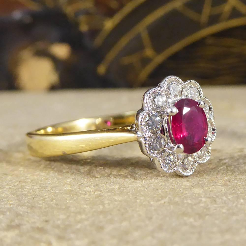 This ring features an oval Ruby weighing approx 0.50ct held in place with a four claw setting, surrounded by 10 round brilliant cut Diamonds weighing approx 0.30ct in total. It has a white Gold head and 18ct yellow Gold band, a classic cluster