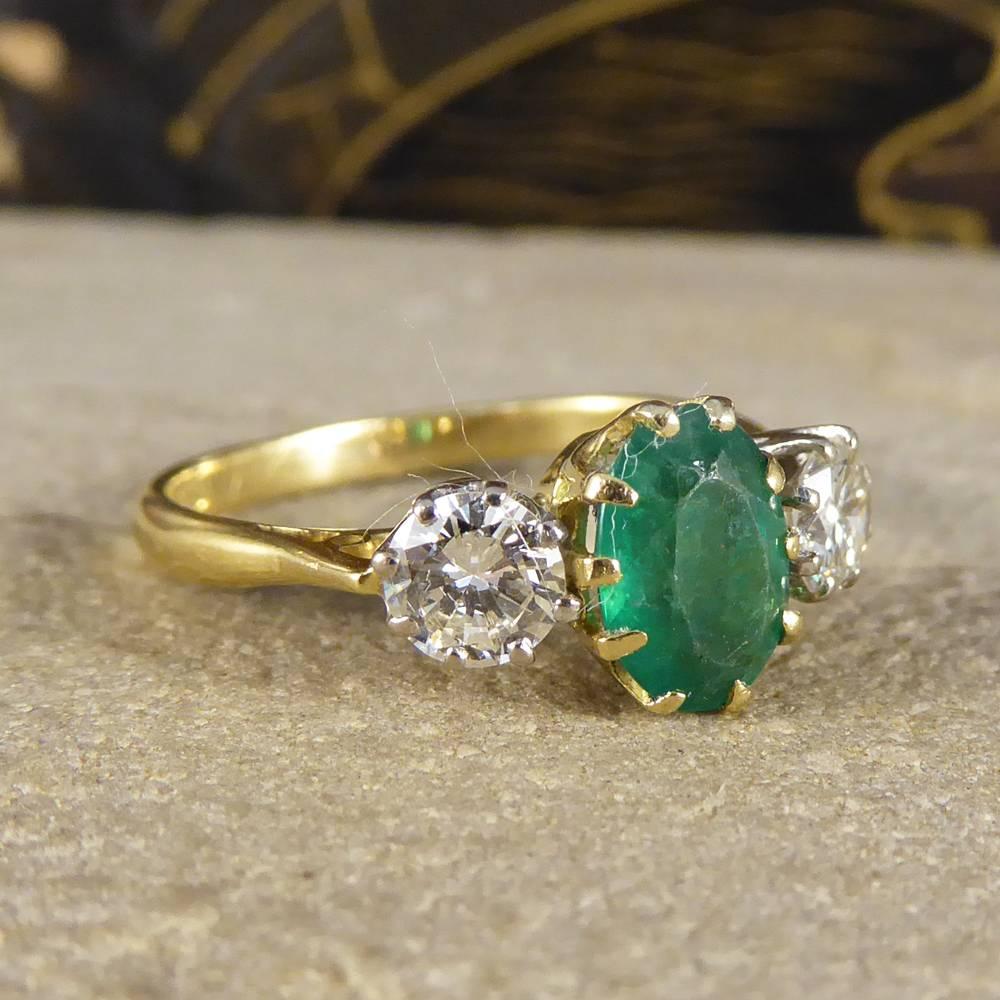 This absolutely stunning 1930's three stone ring features a 1.00ct Emerald stone with two brilliant cut Diamonds at either side. The Diamonds sat in a white gold 8 claw setting and the Emerald sat in a yellow gold 8 claw setting to compliment the