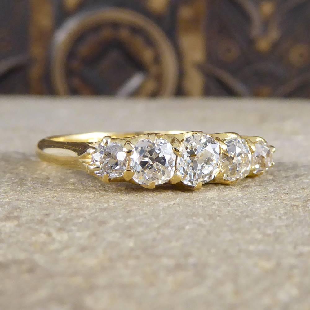 This glorious five stone diamond ring was crafted in the Edwardian era and sits very sparkly on the finger with approx 1.00ct Old Cut Diamonds. With a beautifully simplistic gallery and setting this ring is made from 18ct Yellow Gold.

Centre