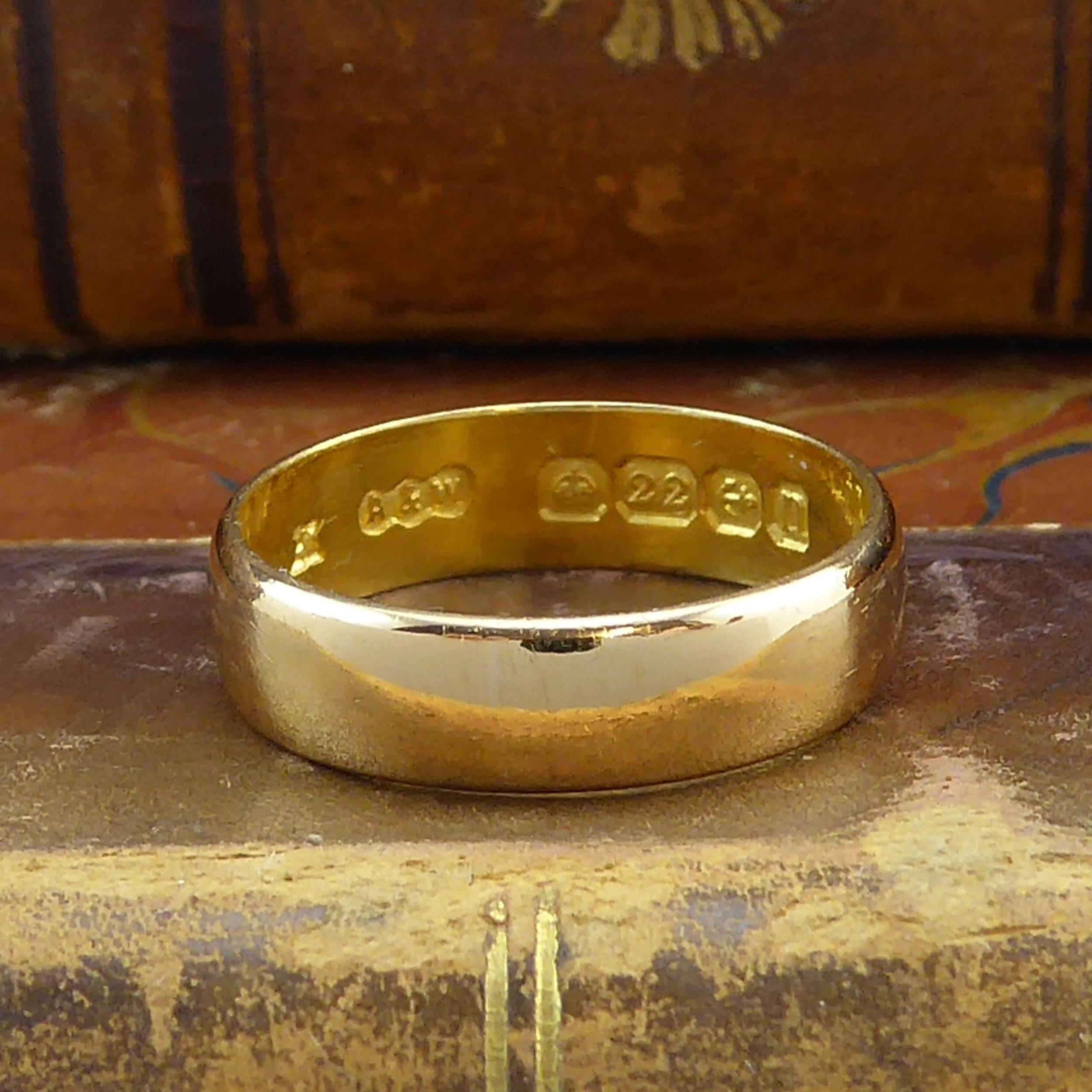 Such lovely antique wedding ring with a low D shaped cross section and with a plain polished finish that may be left as is with the patina of 100 years or polished to a box-fresh finish.

The inside of the band shows the hallmarked 22 carat gold