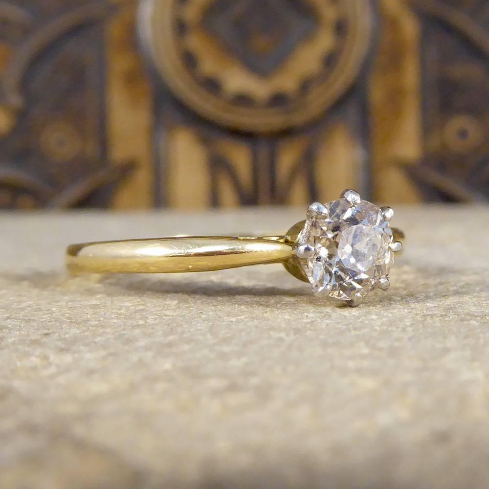 A simple and elegant Diamond solitaire ring, the perfect antique engagement ring. Weighing 0.50cts, this Diamond is mounted in an 18ct white Gold claw setting with lovely simplistic detail attaching the shank and the 18ct yellow Gold band. Perfect