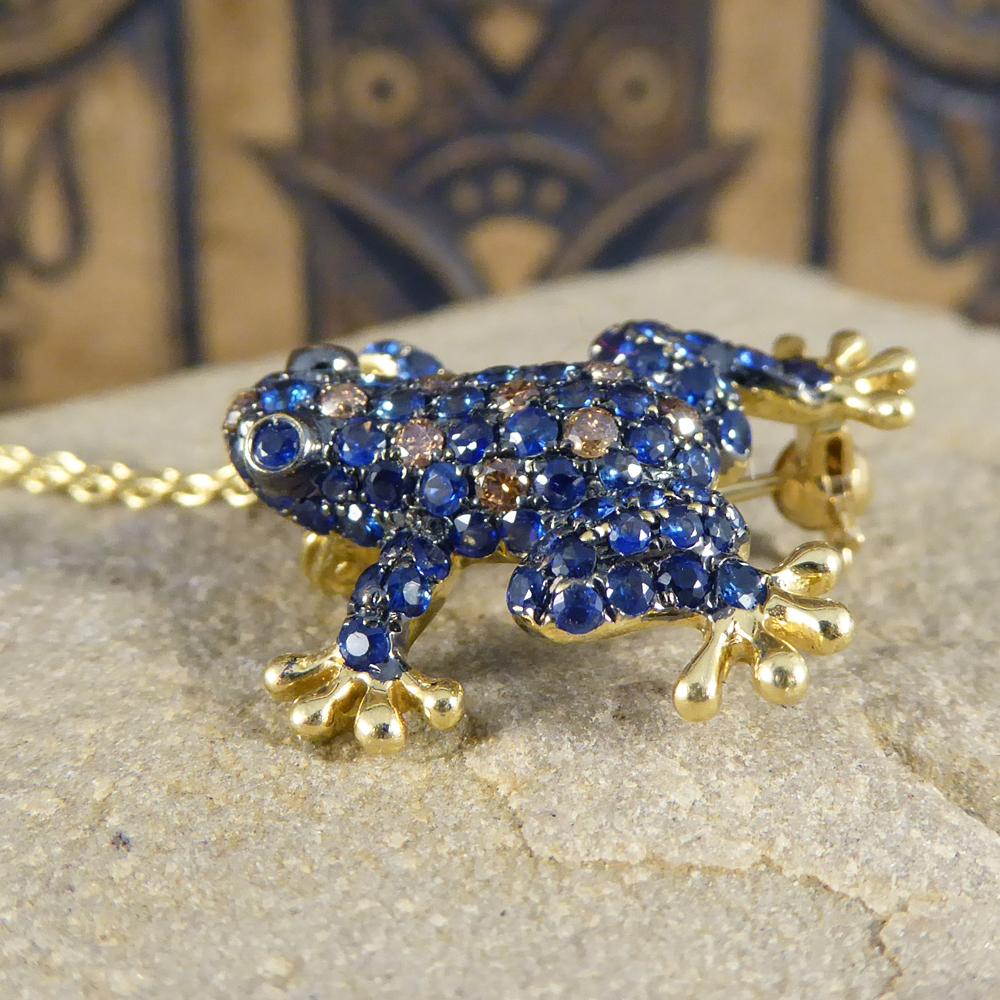 Such an adorable piece of jewellery, can be worn as a pendant on a chain or brooch. This gorgeous little frog is adorned with Sapphires and Champagne Diamonds with gem set eyes, a cute little addition to any outfit. This pendant comes with a 9ct