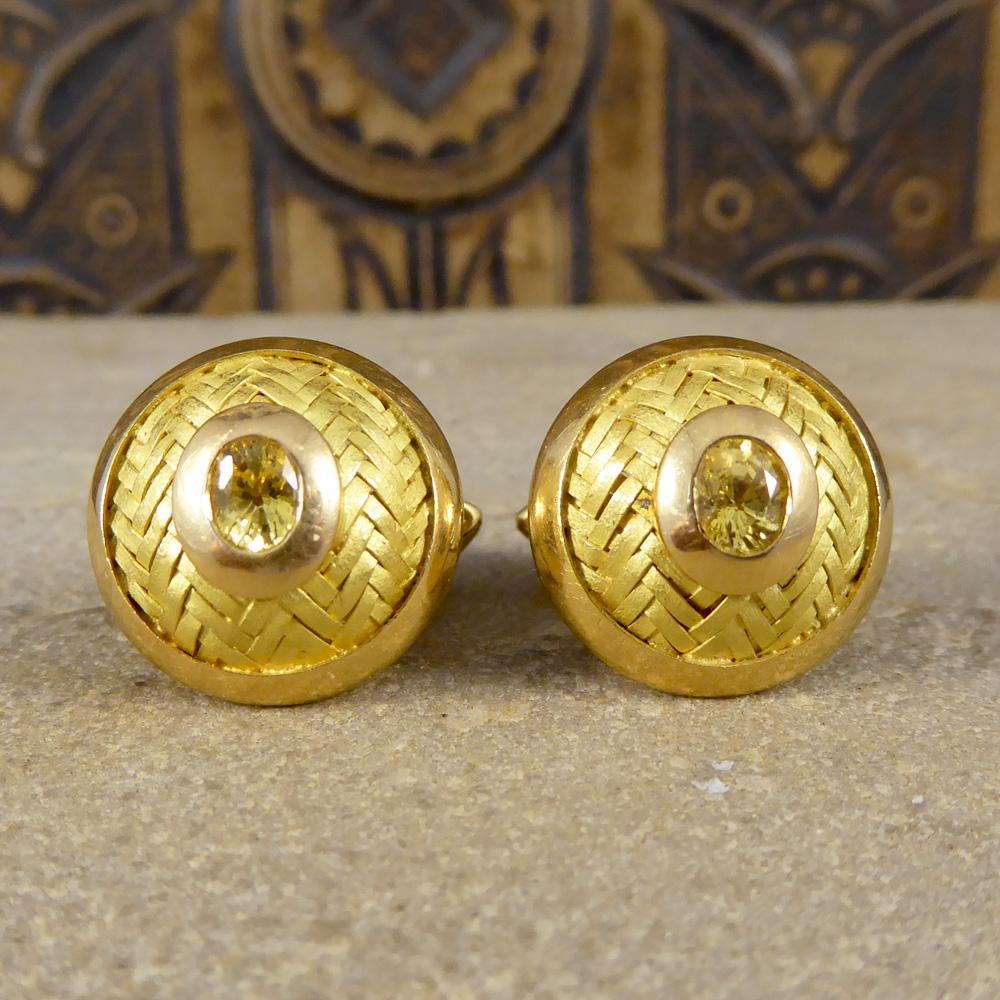These lovely vintage cufflinks have a zigzag pattern running across the circular base. They have a plain border around the edge of both the cufflinks and the Yellow Sapphire gem that sits in the centre. All crafted from 18ct yellow Gold, these would