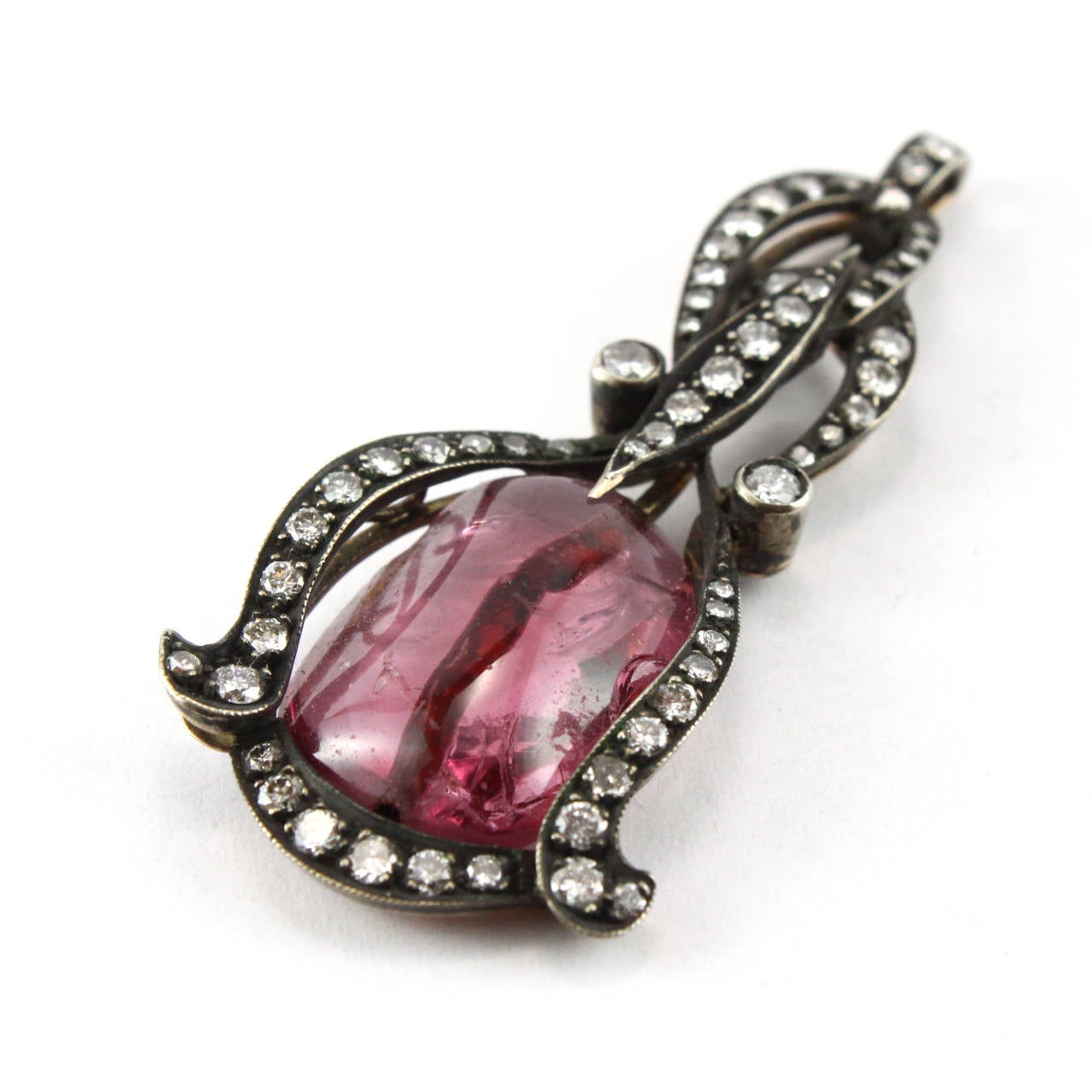 An unusual antique Rubellite Tourmaline bead, mounted in a Victorian pendant with ca. 2 carats of round diamonds.