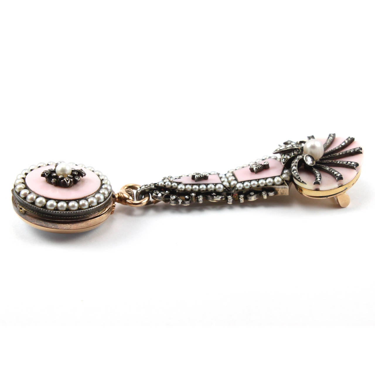 A pocket lapel watch attached to a pendant brooch, ca. 1910. This jewellery item is crafted in a very beautiful combination of pink shell, pearls and diamonds and mounted in 18k yellow gold. It's an exceptional piece and in an excellent condition -