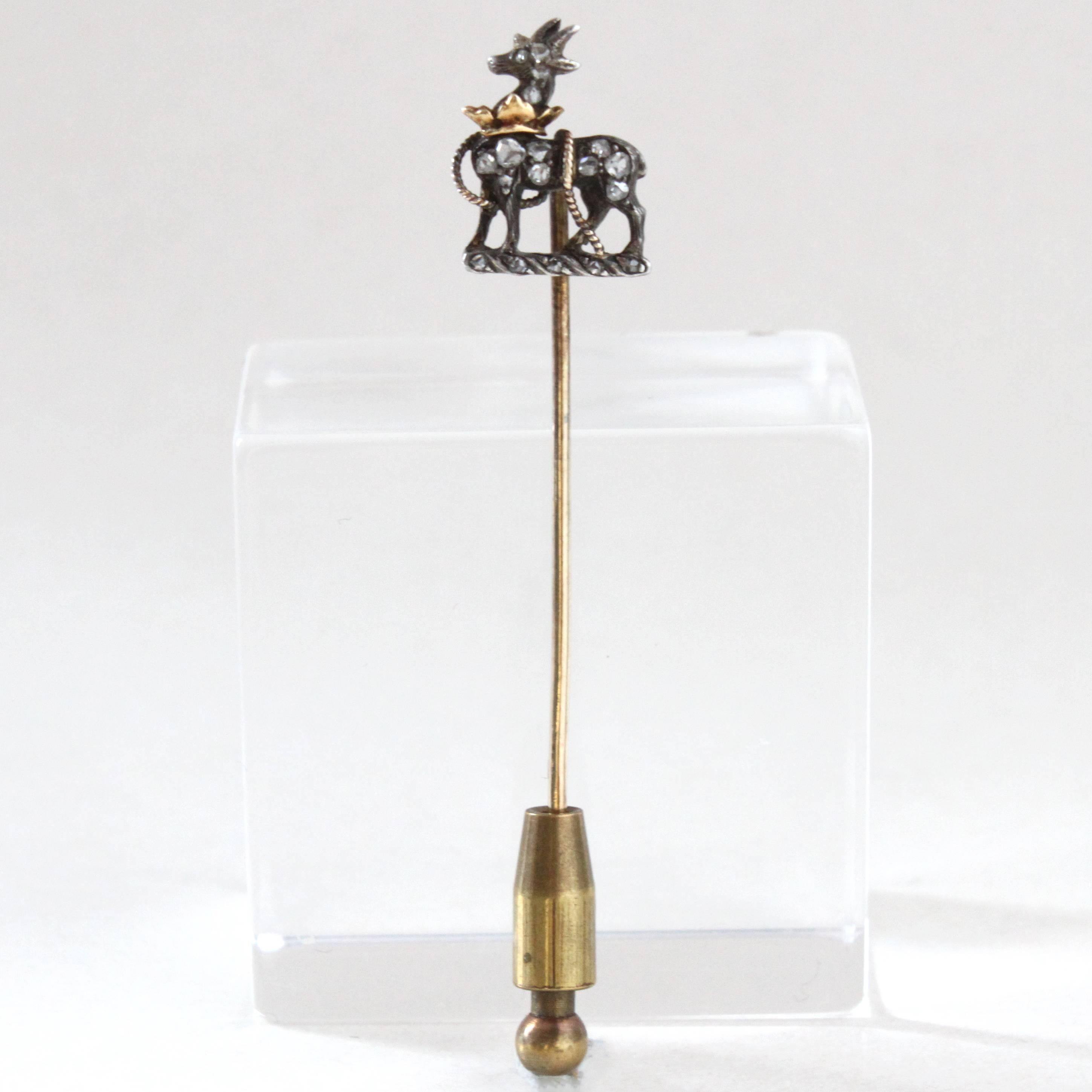 A Victorian Diamond Stag Stick Pin with beautiful details, ca. 1890s.

The motif depicts a stag wearing a gold crown on its neck and tied with gold-ropes around its body. The body itself is studded with rose-cut diamonds.

