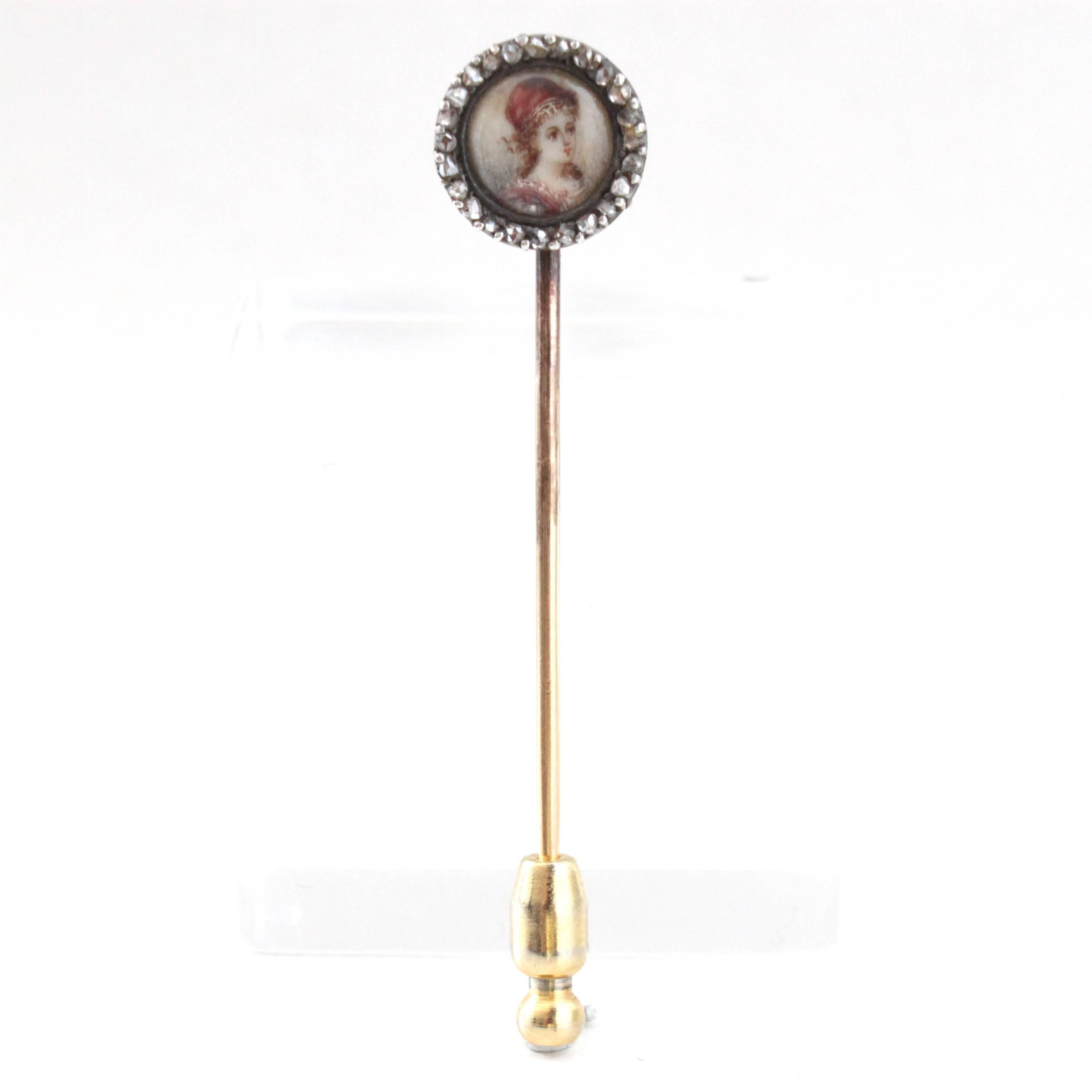 A Victorian Diamond and Enamel Portrait Stick Pin, ca. 1890s.

The centre piece portraits a maiden in enamel work, surrounded by rose-cut diamonds.