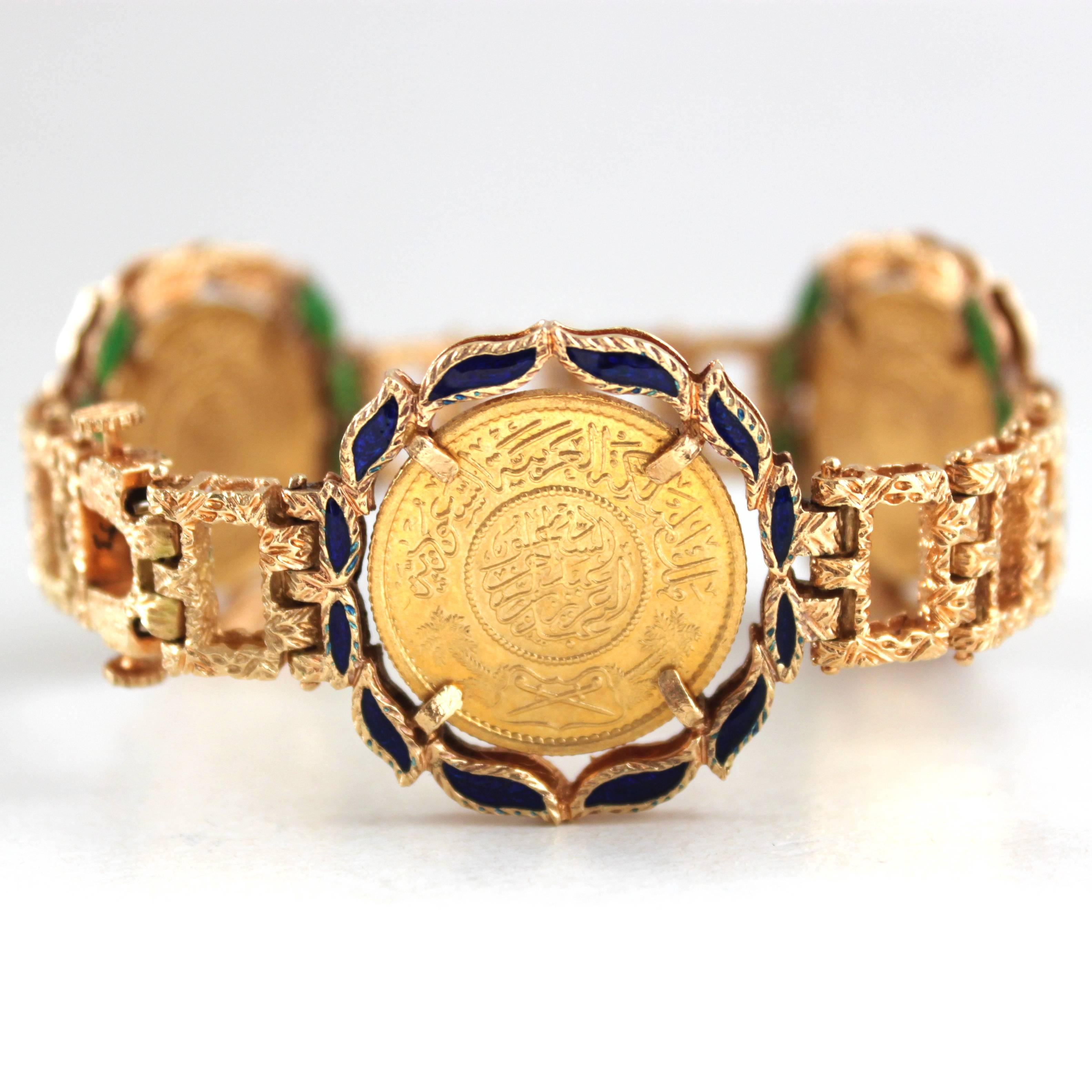 A beautiful and collectible 18k gold and enamel bracelet, with three 22k gold coins with Islamic scriptures, surrounded by blue and green enamelled leafs and completed by textured gold links. 

The clasp of the bracelet is reversible, so it can be
