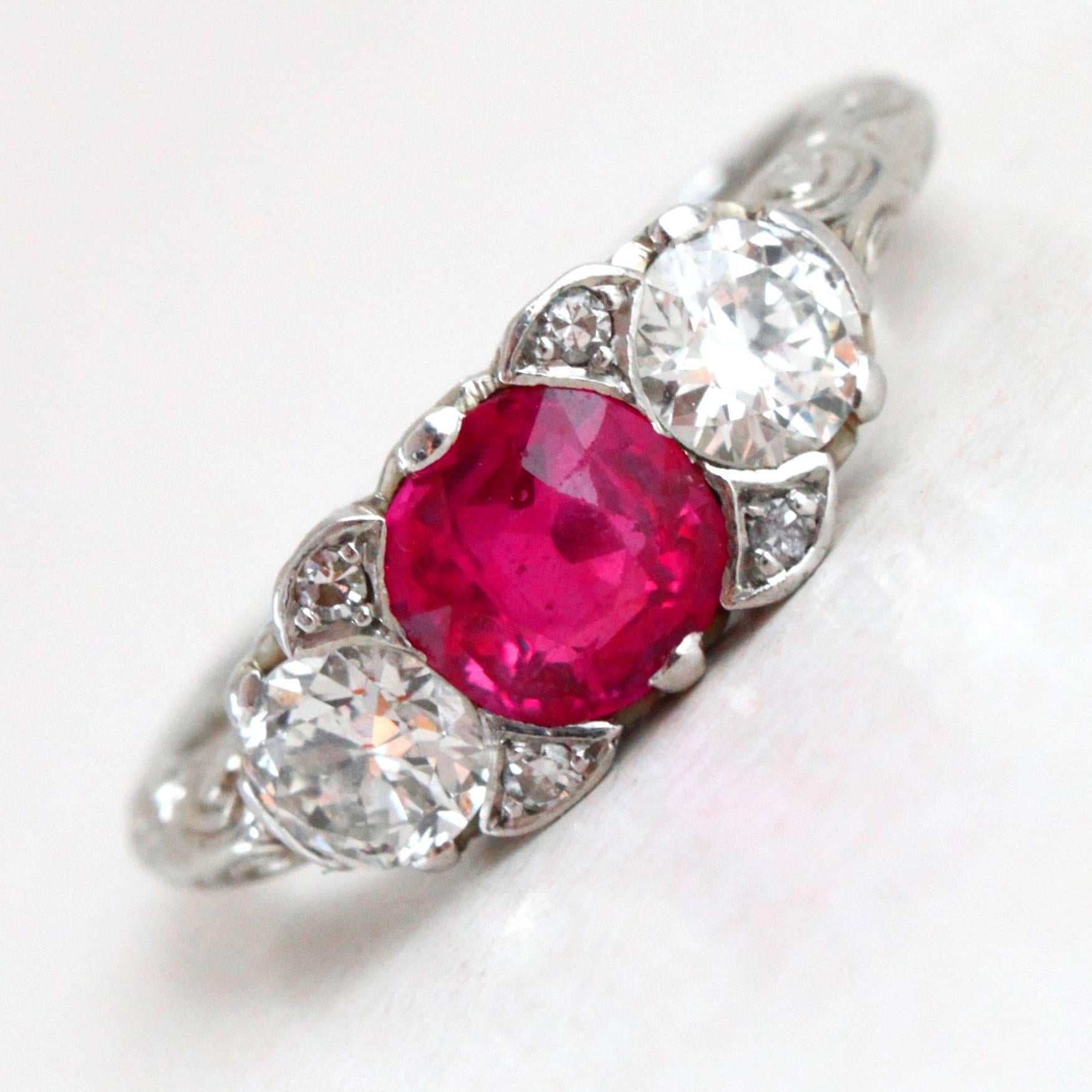 natural Burmese Ruby and Diamond Three Stone Ring, ca. 1920s.

The central ruby weighs ca. 1 carat and is of a very gem quality (Burma no heat), it is surrounded by two diamonds of ca. 0.6 carats (DE/VS-SI quality).

The design of the ring and