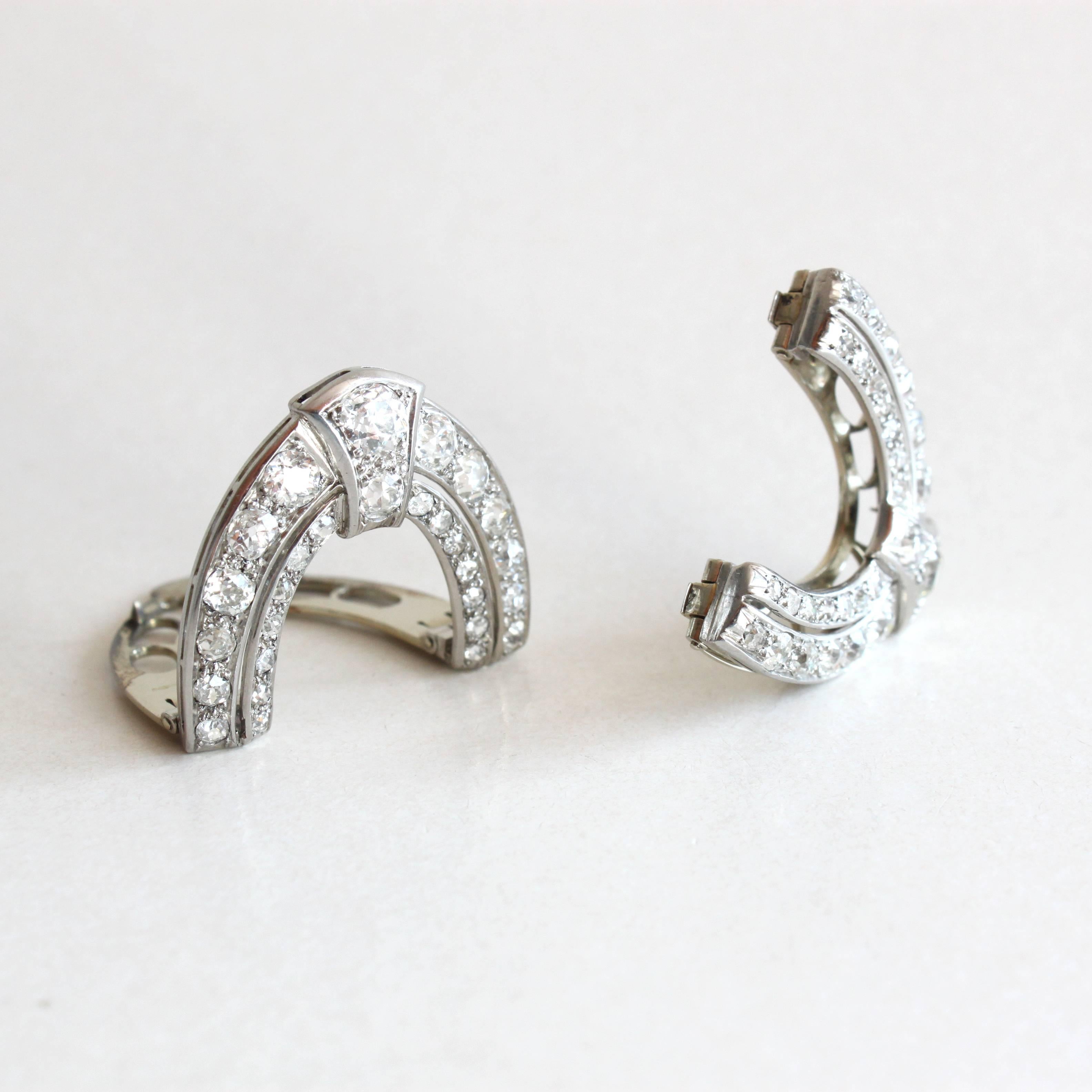 A very chic pair of Art Deco Diamond (ca. 7 carats) Double Clips, ca. 1930s.

These beautiful Art Deco clips designed as arches, can be worn in a variety of manner, e.g. on the cuff, collar, hat, with the partner, etc. etc.
This makes them really