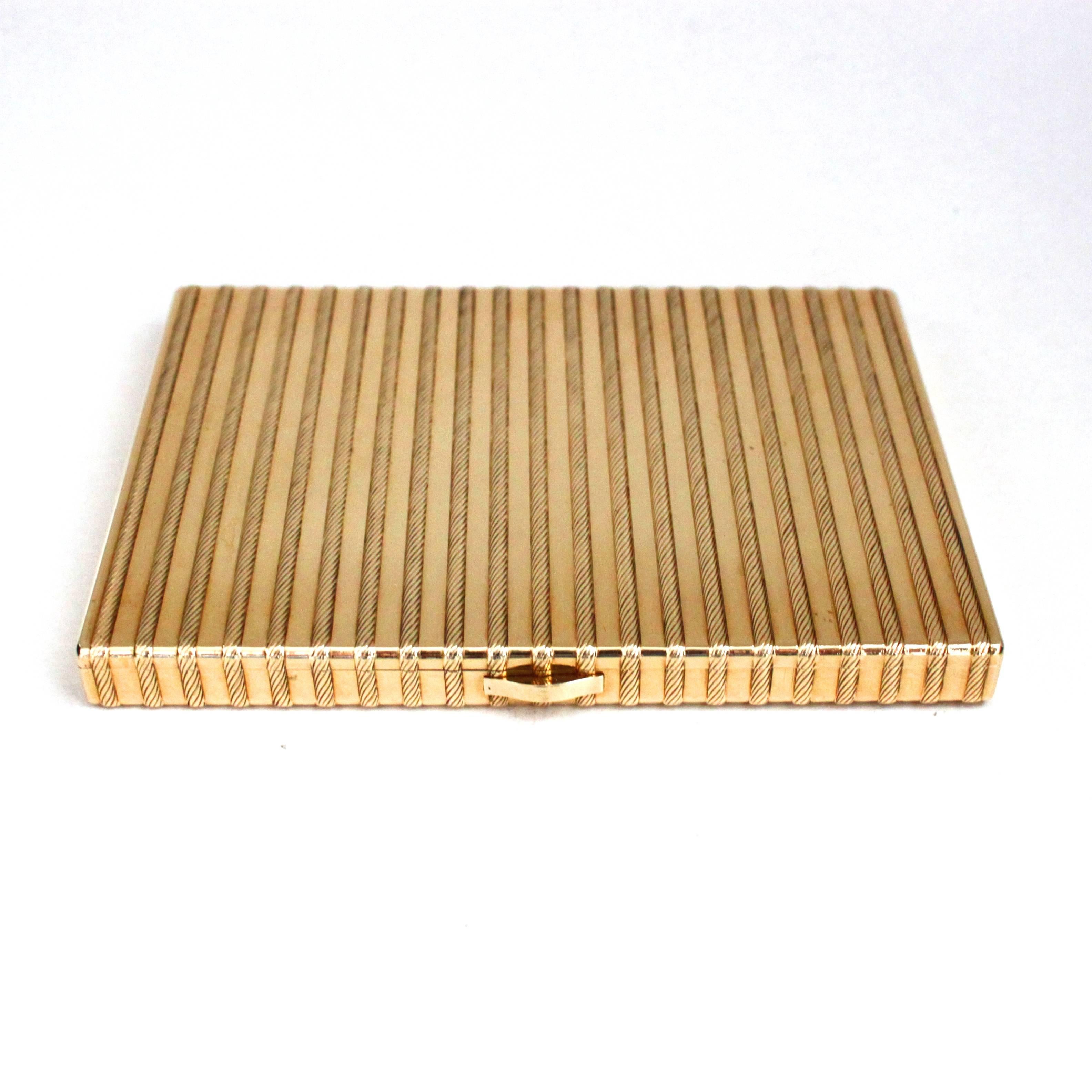 A beautiful Cartier Gold Cigarette Case, ca. 1940s-1950s,
with a beautiful design of ropes all around it, made in 18k gold.
A cigarette safety latch is installed inside the compartment.

Signed Cartier Paris, numbered, hallmarked.