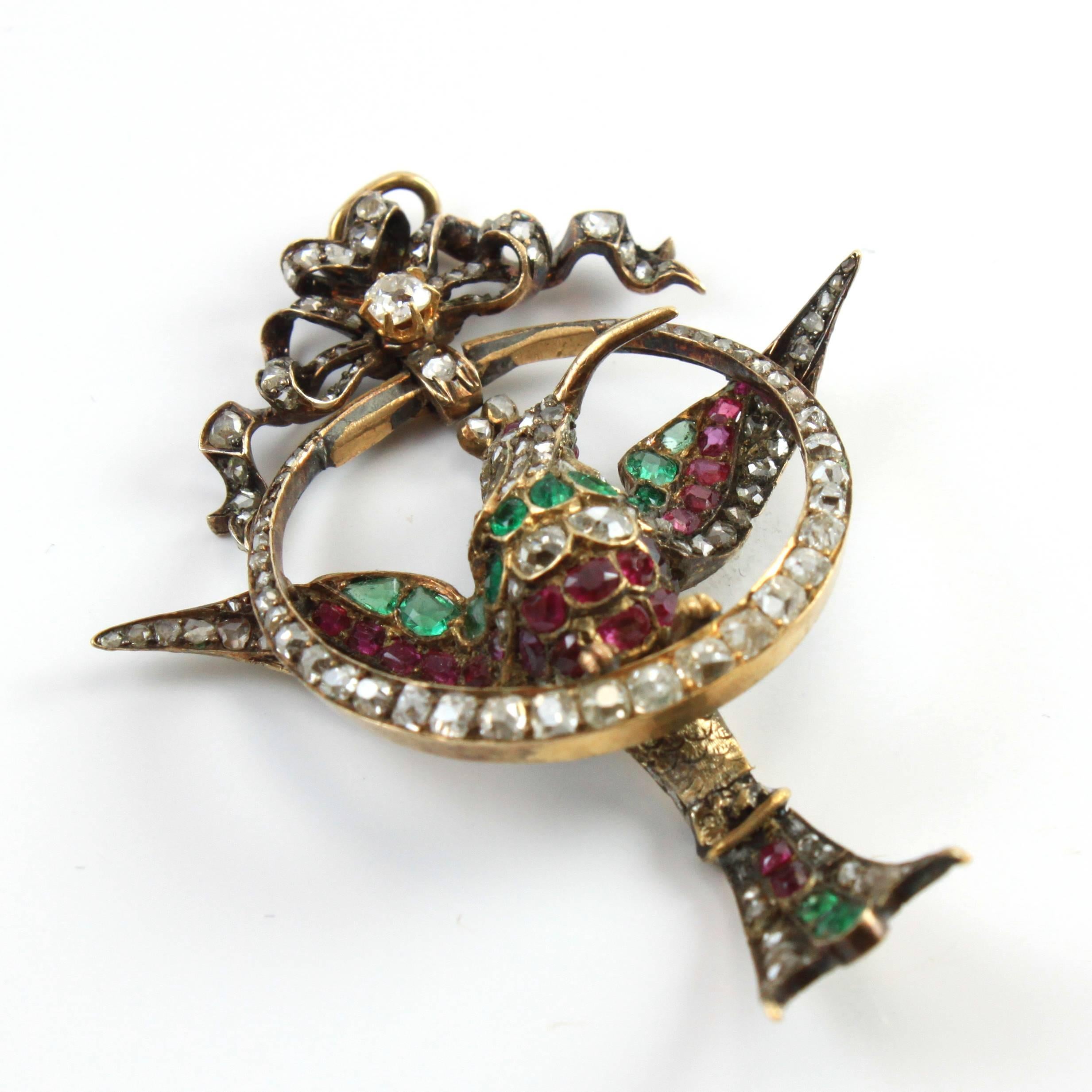 A stunning antique pendant in the form of a mockingbird, with old cut diamonds, rubies and emeralds. The craftsmanship is exceptional and as common during the time it is made in silver and gold. This pendant is a fascinating piece of jewellery and