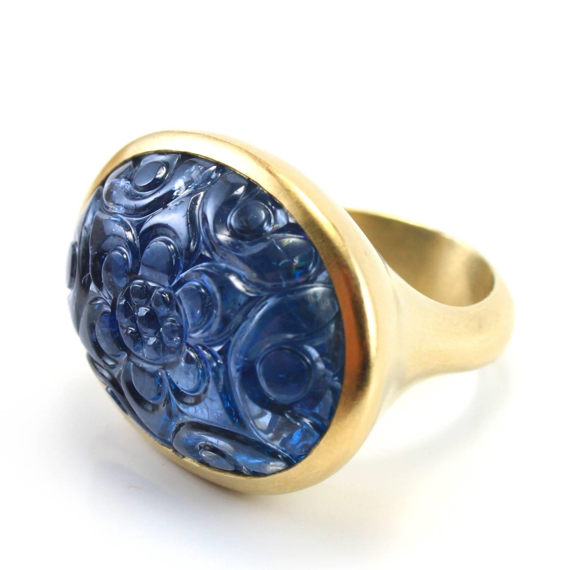 A very chic large carved sapphire ring with a natural sapphire of circa 45-50 carats, beautifully carved with a Mughal floral motif. The sapphire has been tested to be natural.

Floral motifs such as the Buta began to gain importance in the Mughal