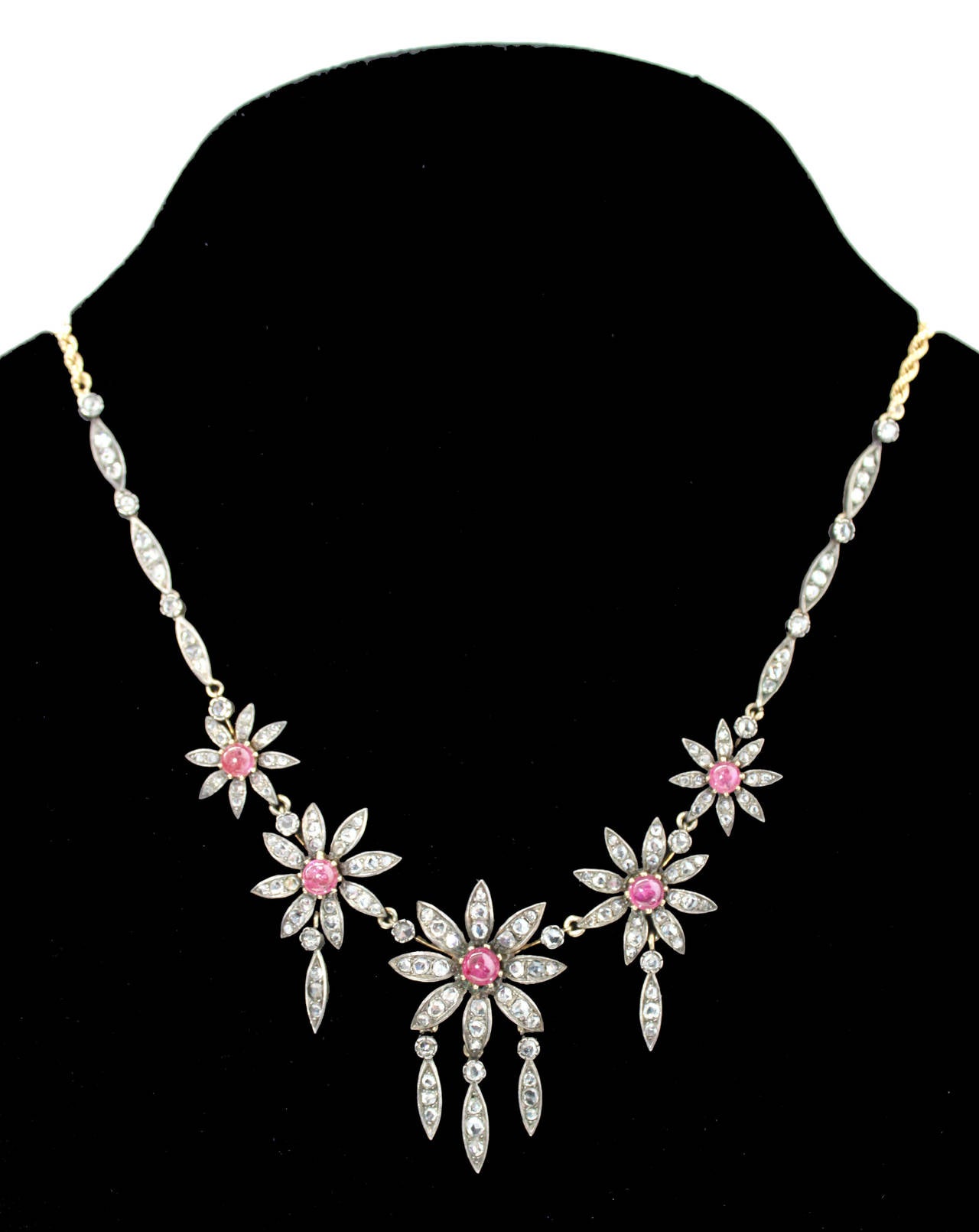 Victorian ruby and diamond necklace in silver and gold, 1890s. The 5 ruby cabochons are natural Burma rubies and display a fine colour and crystal. The weight of the rubies is circa 3-4 carats. The diamonds are rosecut diamonds and weigh circa 5
