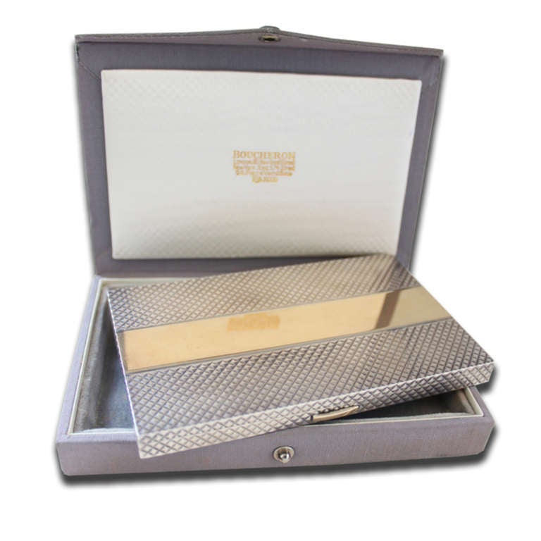 An Art Deco gold and silver box by Boucheron with a strong symmetrical design. Signed and numbered. With original fitted box.