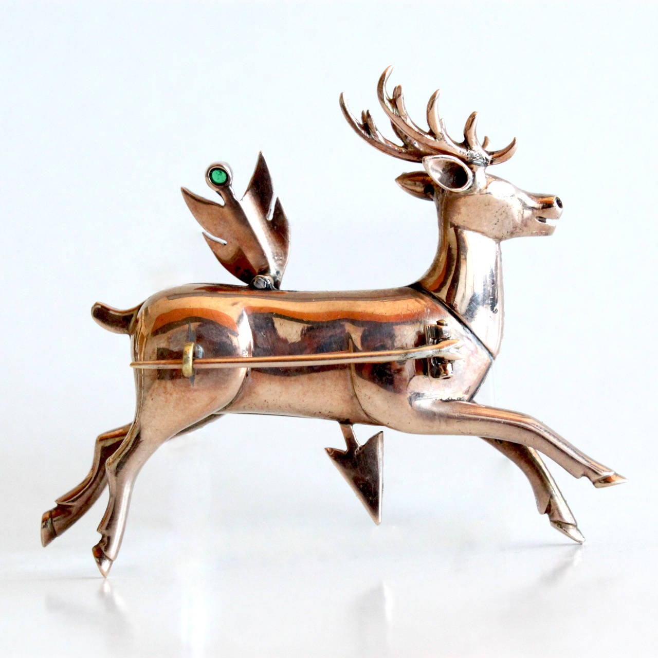 A very unusual and large Antique Diamond Stag and Arrow Brooch.
The deer body and the arrow are set with rose-cut diamonds of ca. 4-5 carats, rubies and an emerald. The piece is made in yellow gold.

The symbol of a stag and an arrow can be