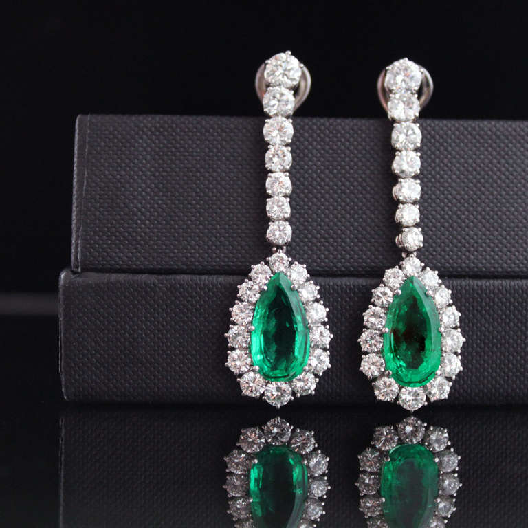 Important emerald and diamond earrings from the 1970s, each set with beautiful Old Mine Colombian emerald and surround by round brilliant cut diamonds of a very fine quality. The emeralds weigh 8.67 carats together and the total diamond weight is