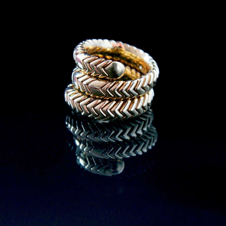 A chic Bulgari Spiga Ring in the design of a snake in 18k yellow gold. The design makes the ring size flexible. Ring size 6-up. Signed and numbered.