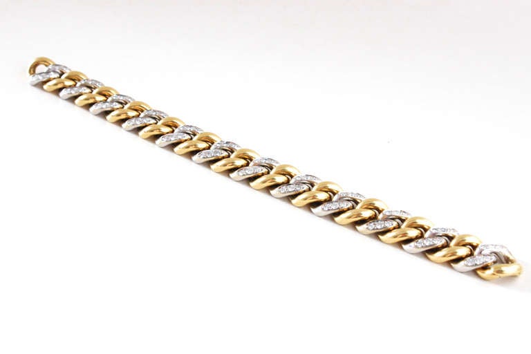 A very pretty diamond bracelet by Pomellato. Each link is uniquely designed with white and yellow gold, and studded with circa 2.8 carats of diamonds. The bracelet closes harmoniously with an invisible clasp. Signed.