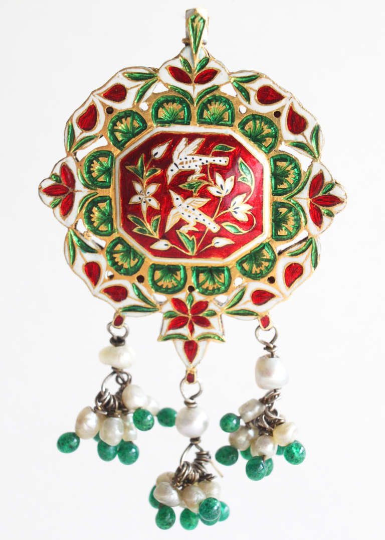 Antique, 19th Century, Indian enamel head bena pendant, centering a big table cut foliated emerald. Surrounding the center are table cut diamonds and emerald cabochon depicting a floral motive. The hair ornament, which can also be worn as a neck