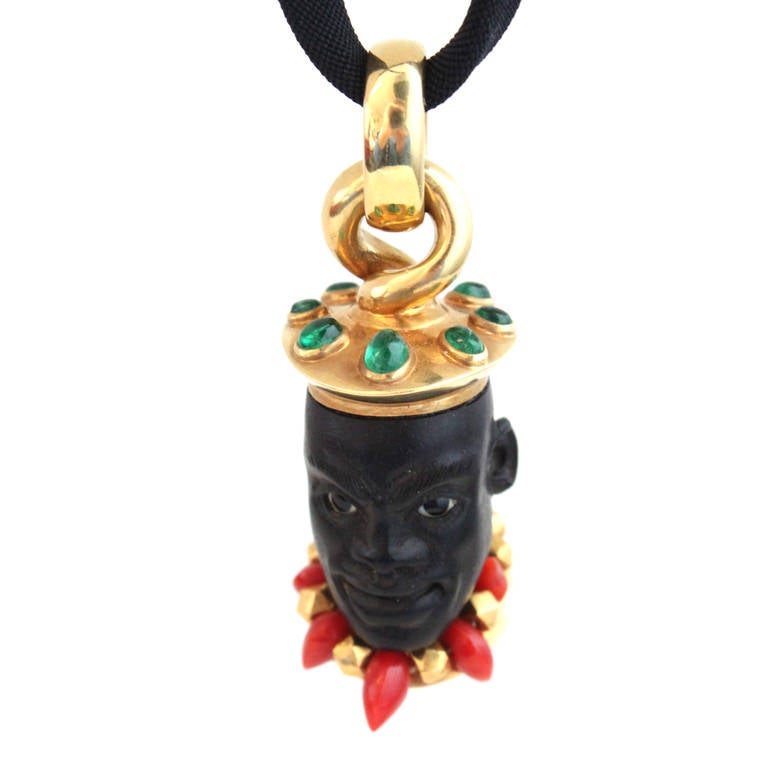 The pendant depicts a carved face in Ebony with Emerald cabochons and Coral. As with all Otto Jakob pieces the pendant's high craftmanship is easily noticeable. The piece is signed by Otto Jakob. 

About Otto Jakob
Otto Jakob is a German artisan
