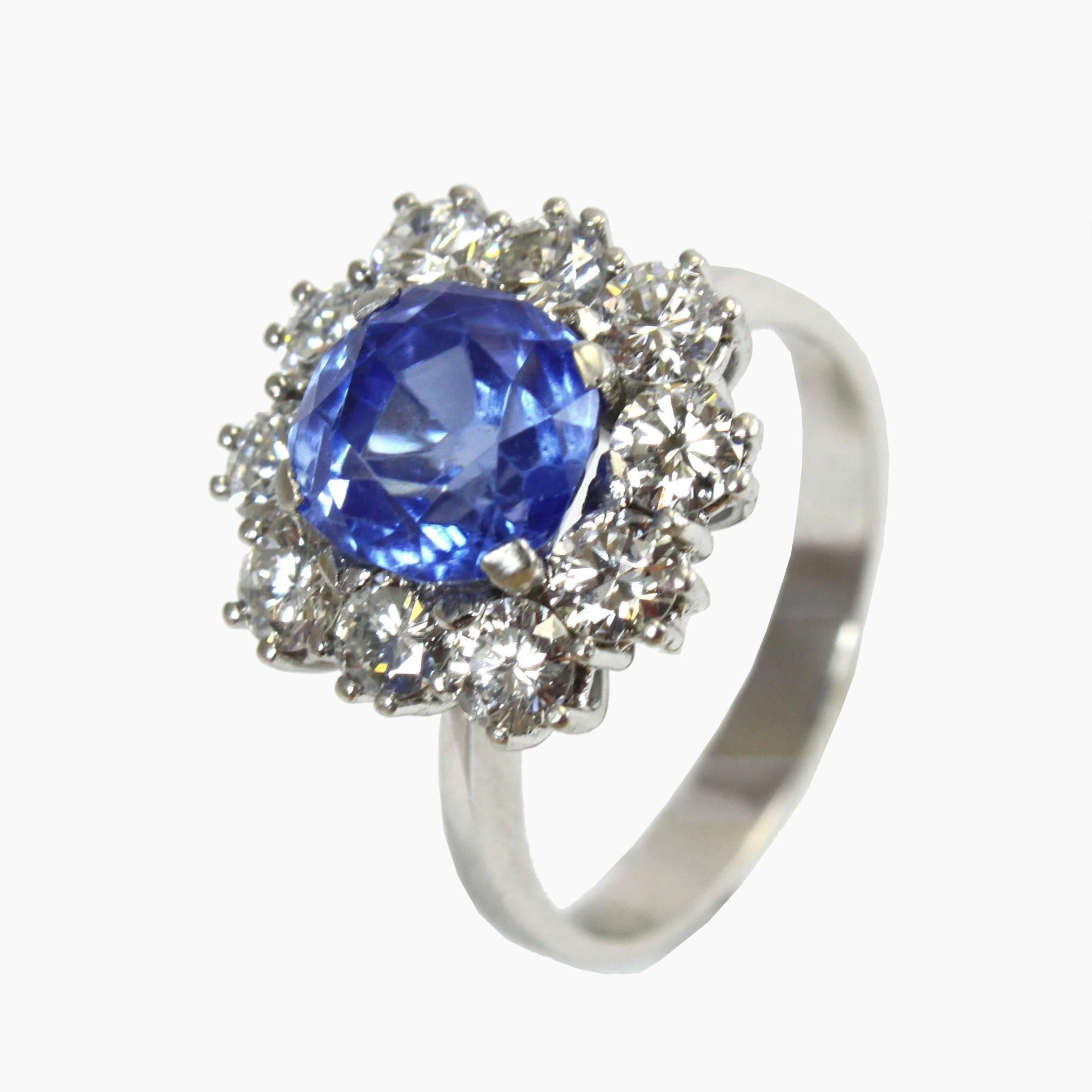 The cluster ring centers a rare natural unheated Kashmir sapphire and is surrounded by brilliant cut diamonds. 

The Kashmir weighs 3.42 carats and is certified by SSEF. It has a beautiful cornflower blue colour, as typical for Sapphires from the