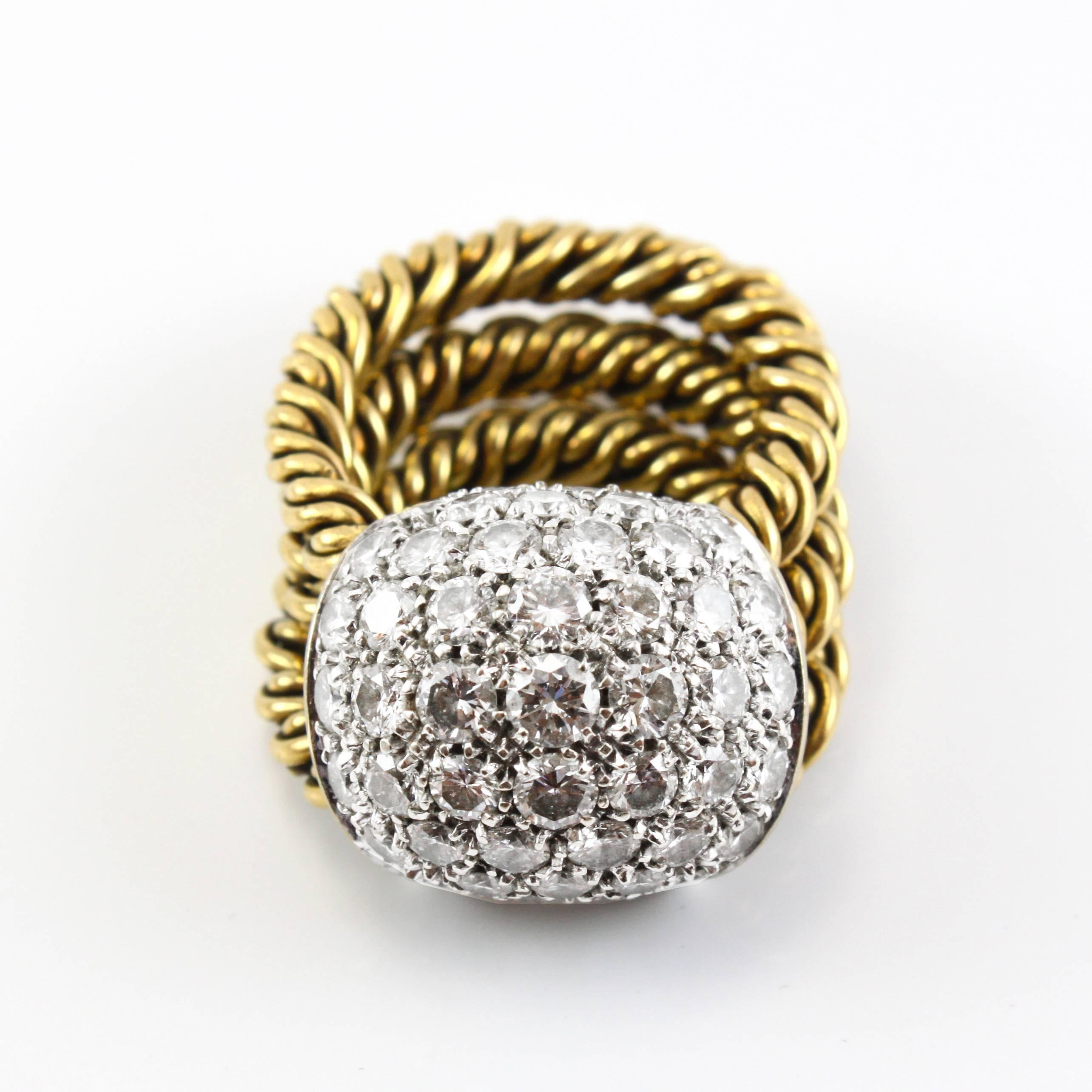 Playful diamond and gold ring by Pomellato. The diamonds are mounted on a dome shaped 18k white gold track which moves along the three woven 18k yellow gold ring bands. It is a fabulous piece that can be worn every day and feels very comfortable,