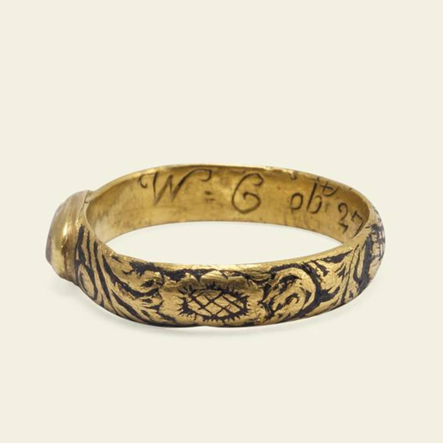 This spectacular and rare mourning ring was made in the first years of what is now known as the Georgian era. The head of the ring features a flat cut rock crystal with an oval collet. The crystal houses a well-preserved white enamel skull and