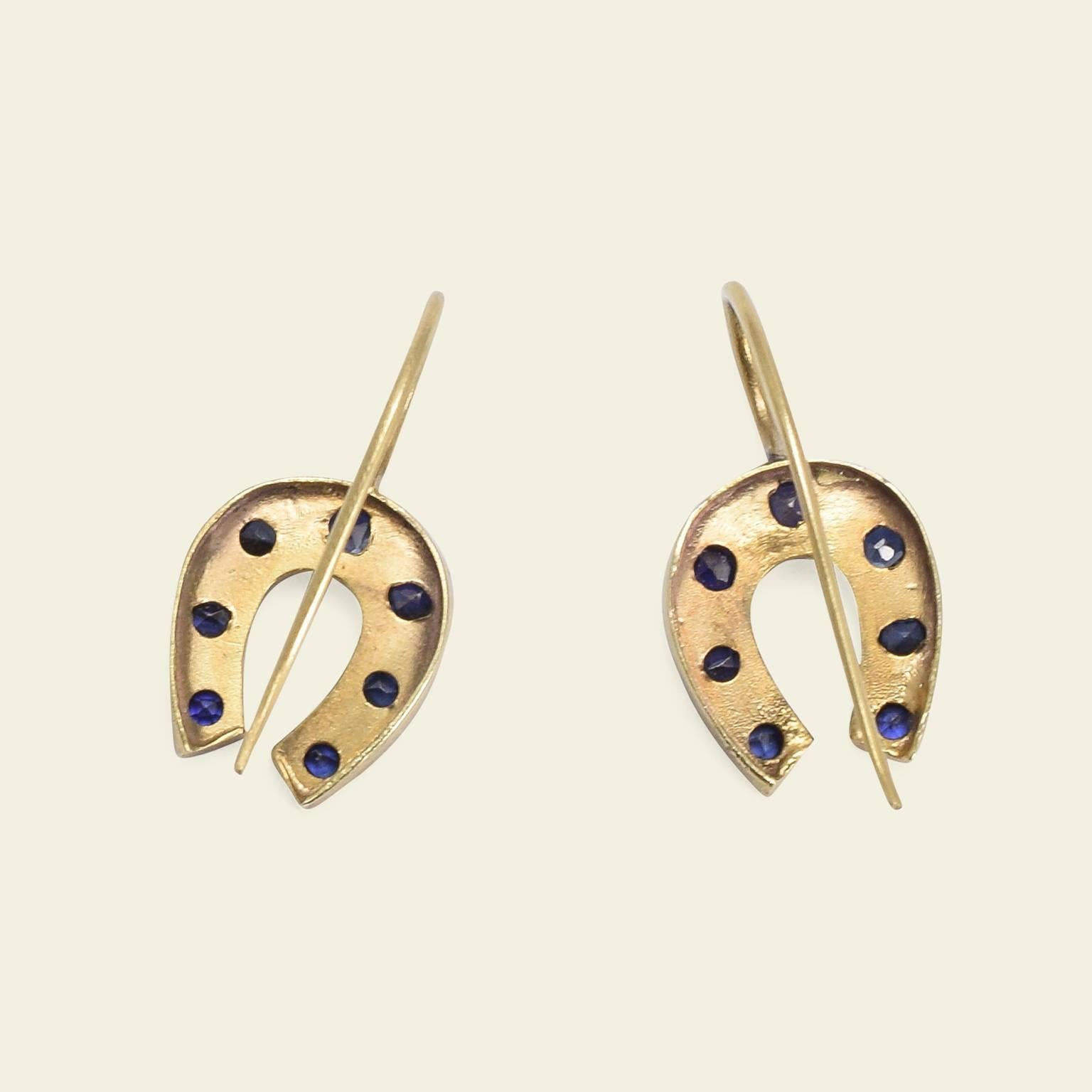 Horseshoes are widely recognized talismans of good fortune. Pointed up, they are thought to collect good luck as it pours down from the heavens. Pointed down - such as with these earrings - and good luck is thought to spill forth from the charm.