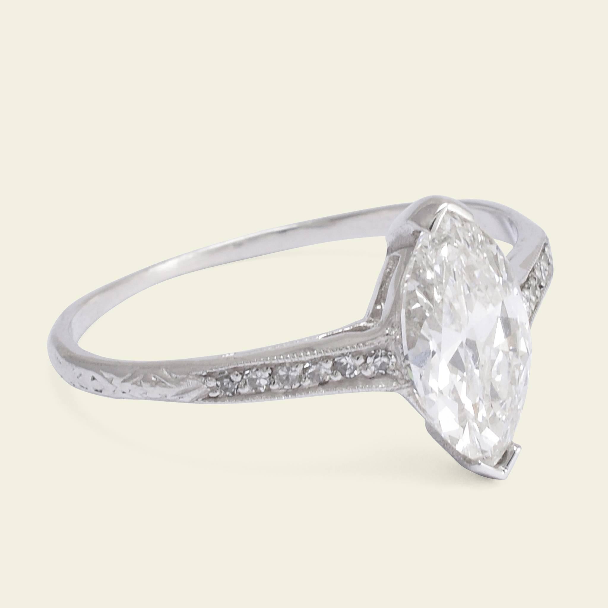 This nontraditional take on a classic engagement ring style dates to the 1930s. Made in platinum, the center stone is a north to south oriented 1.03ct marquise brilliant cut diamond (E/VS1). The marquise cut was supposedly invented in 1745 at the