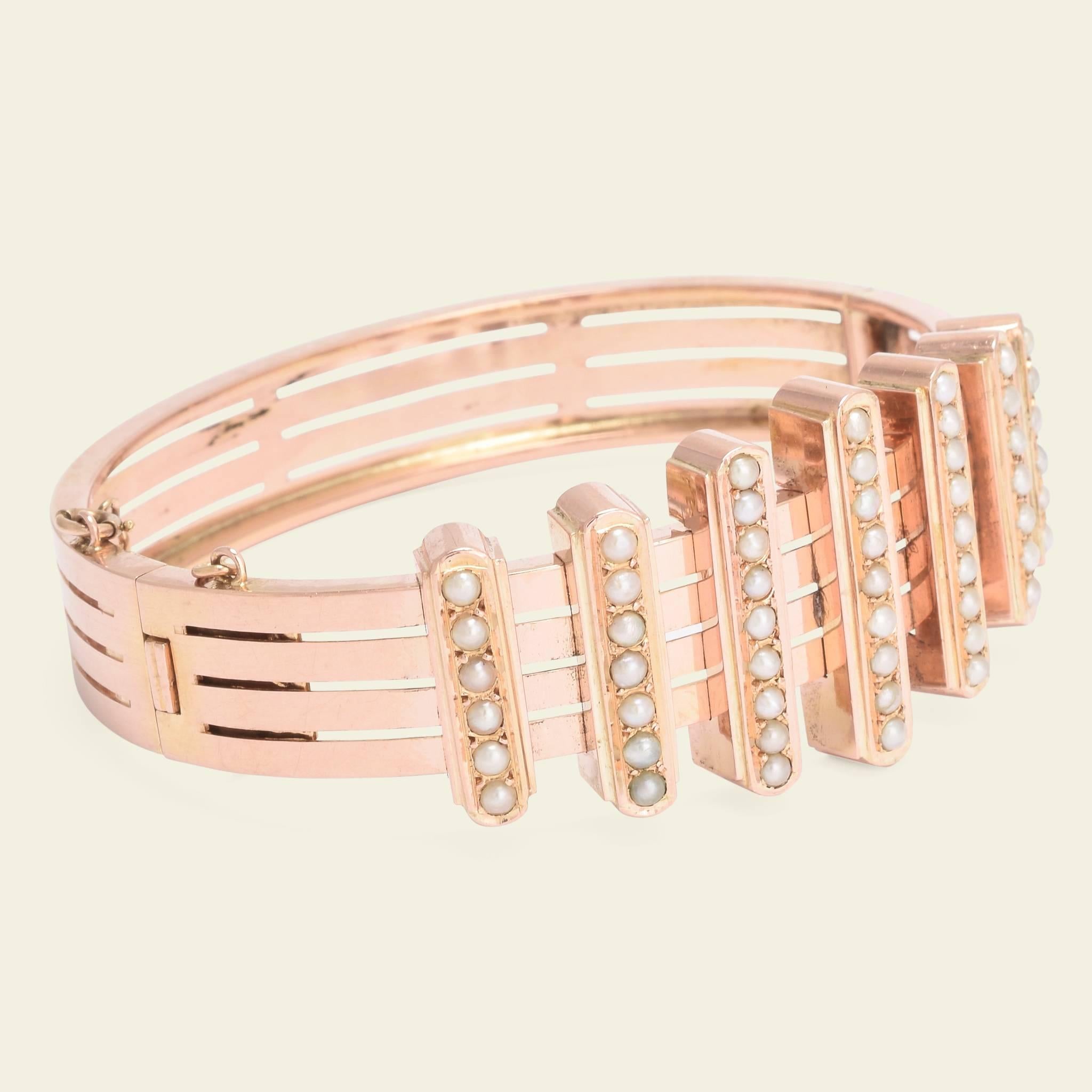 This beautiful Belle Époque bracelet is fashioned in 18k rose and dates to late 19th century France. The shank of the bracelet is composed of four concentric rings punctuated with perpendicular bars along the back of the bracelet, and seven
