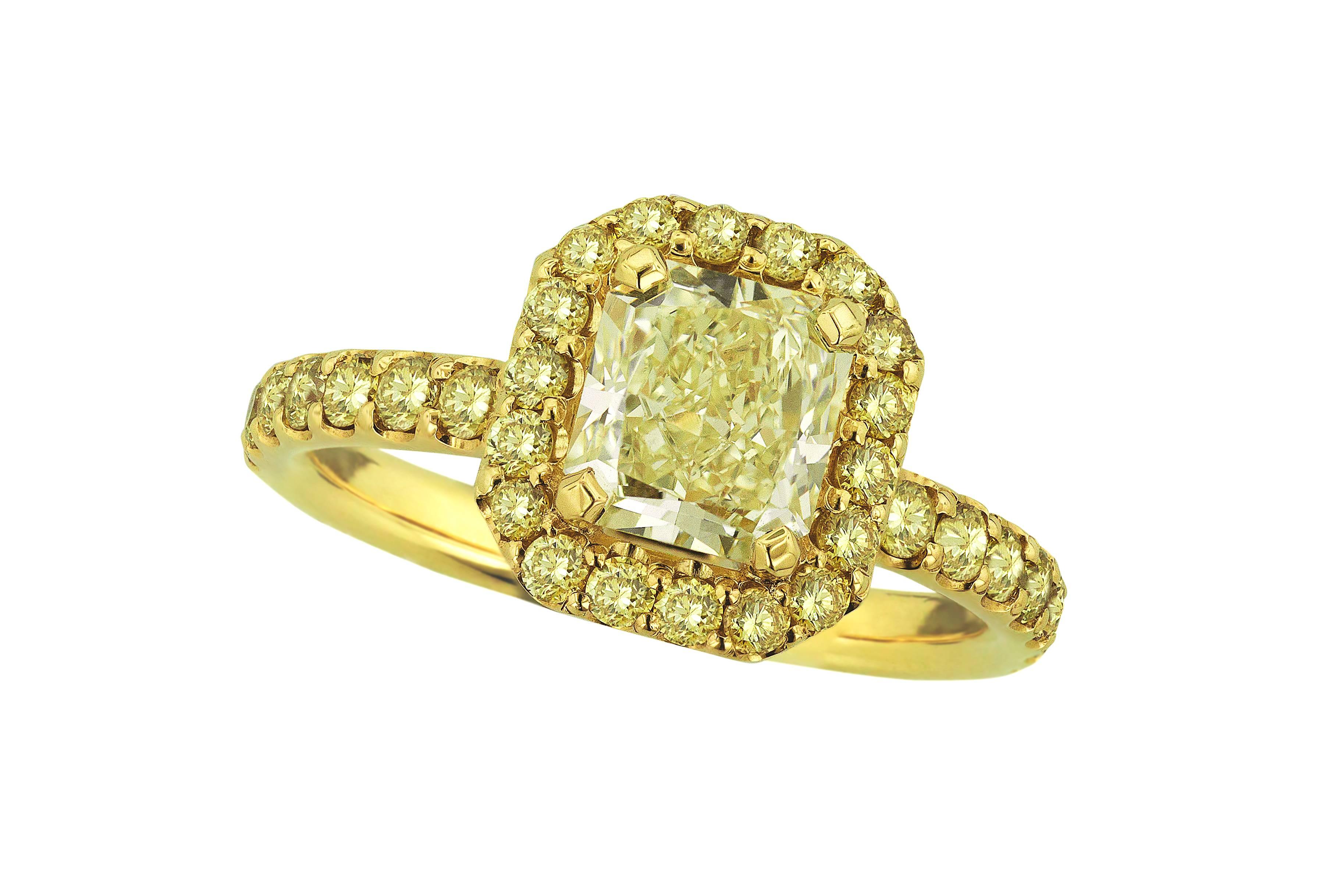 A stunning hand-made creation with spirit, fire and style. Set in 18 karat yellow gold. A dazzling 1.38 carat tinted yellow radiant diamond creates an extraordinary show of light at the ring’s centre. The center stone is encircled by a halo of