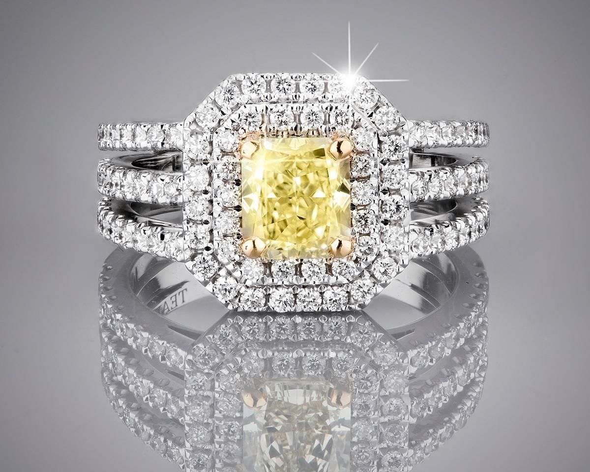 Exclusive brand new engagement ring with a stunning 2.47 carat of natural diamonds. This one-of-a-kind ring is designed with a delicate 18k white gold three band mounting and a very rare 1.21 carat fancy light yellow center stone, encircled by a