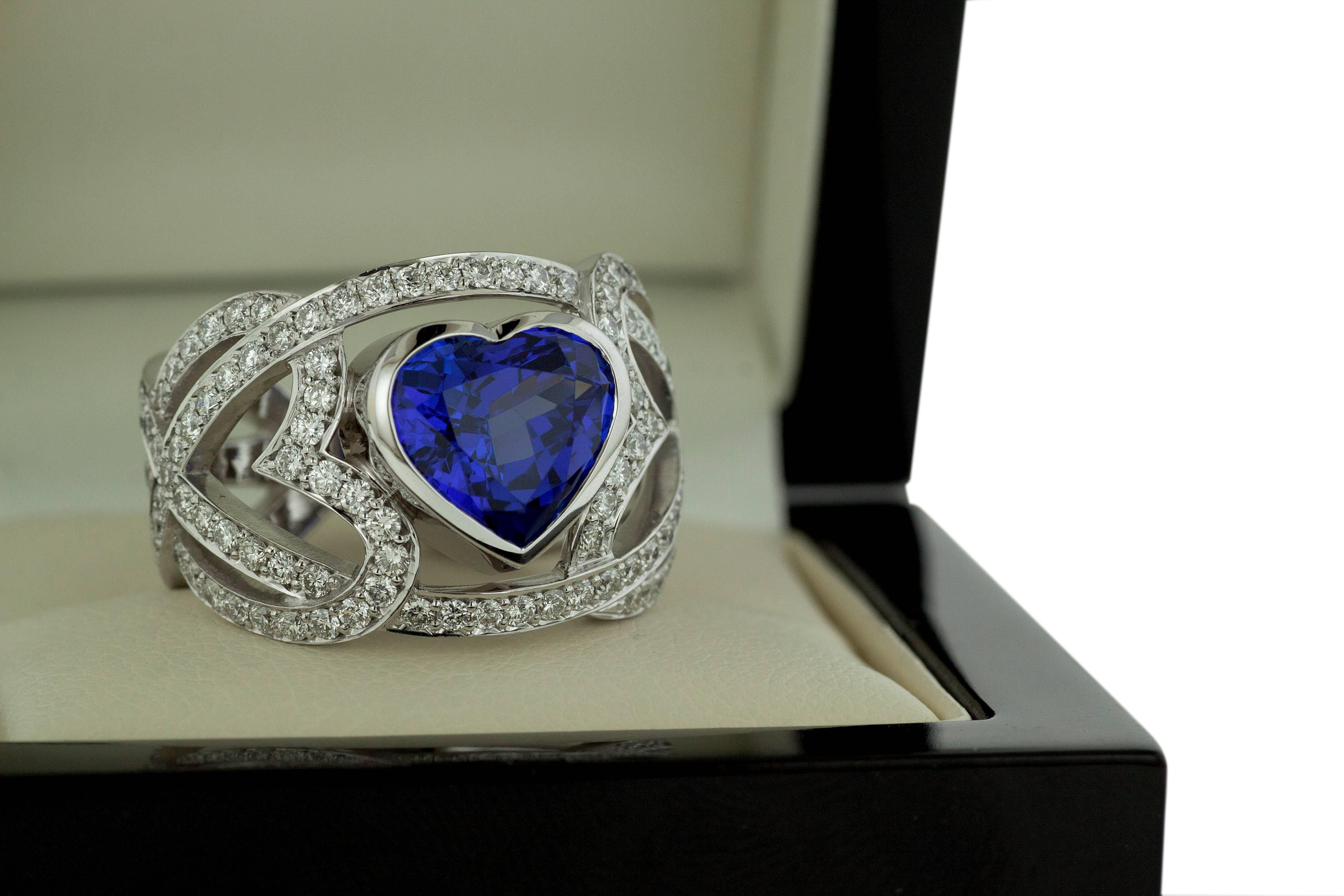 Brand new, one-of-a-kind, dark blue Tanzanite & Diamond fashion ring. The white gold mounting and setting are especially designed to fully protect the heart-cut gemstone, without losing its reflected light sparkle. The tanzanite is surrounded by